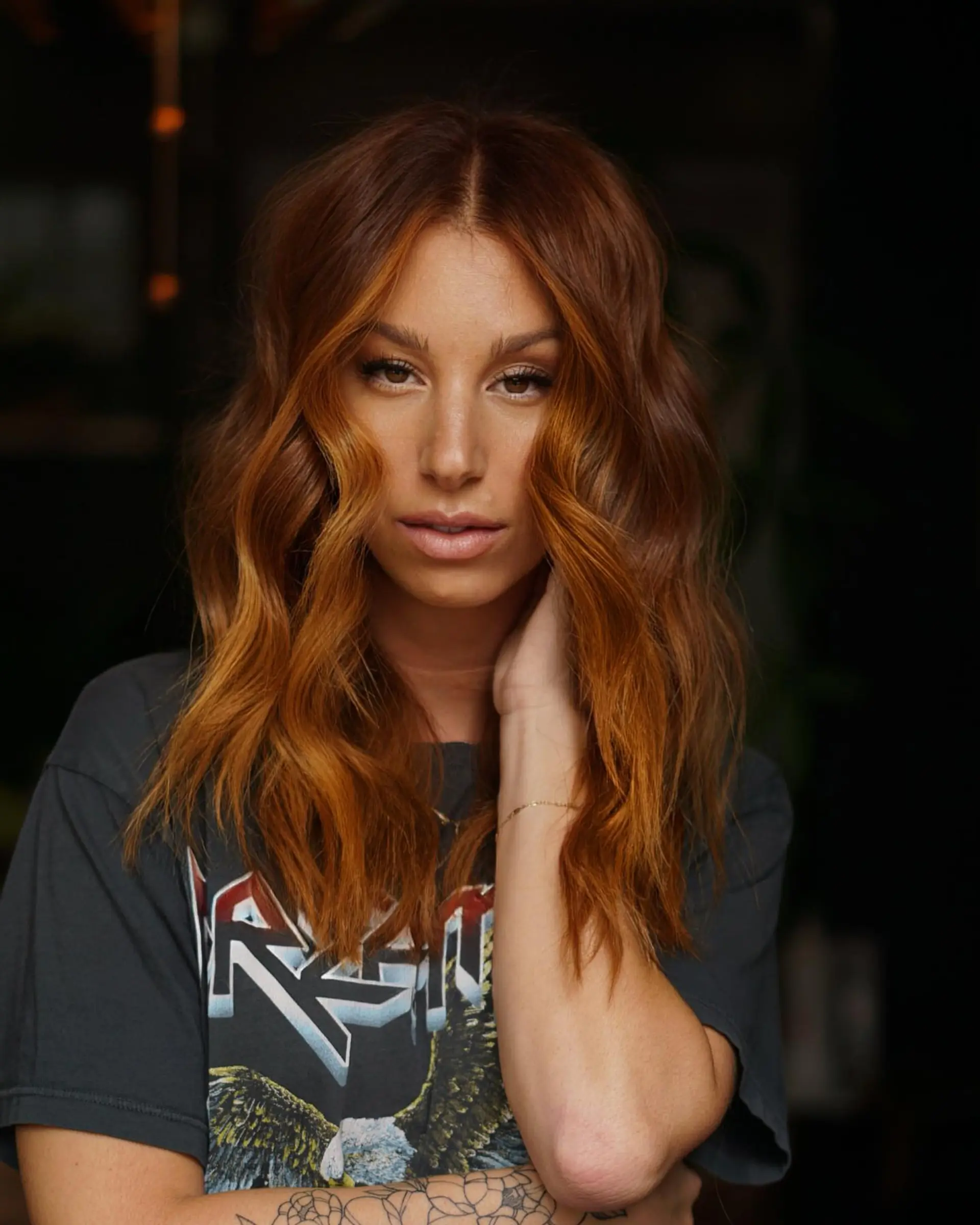 Medium-length cowboy copper hair styled with soft, dimensional waves and lighter face-framing pieces. 1