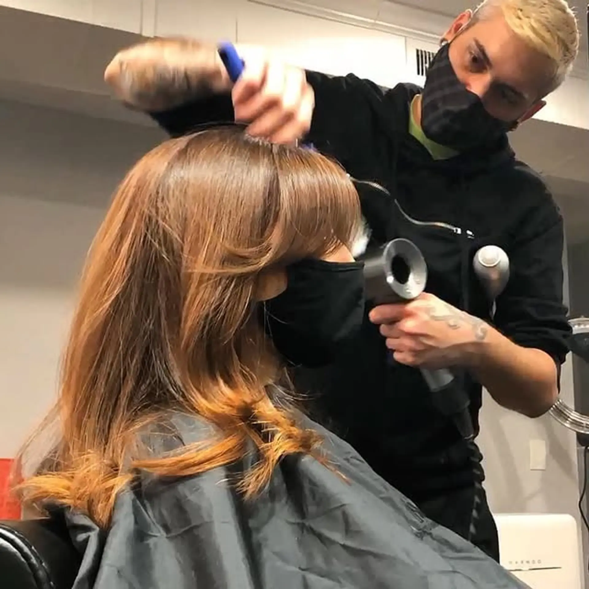 This style features long, layered hair with modern curtain bangs. 1