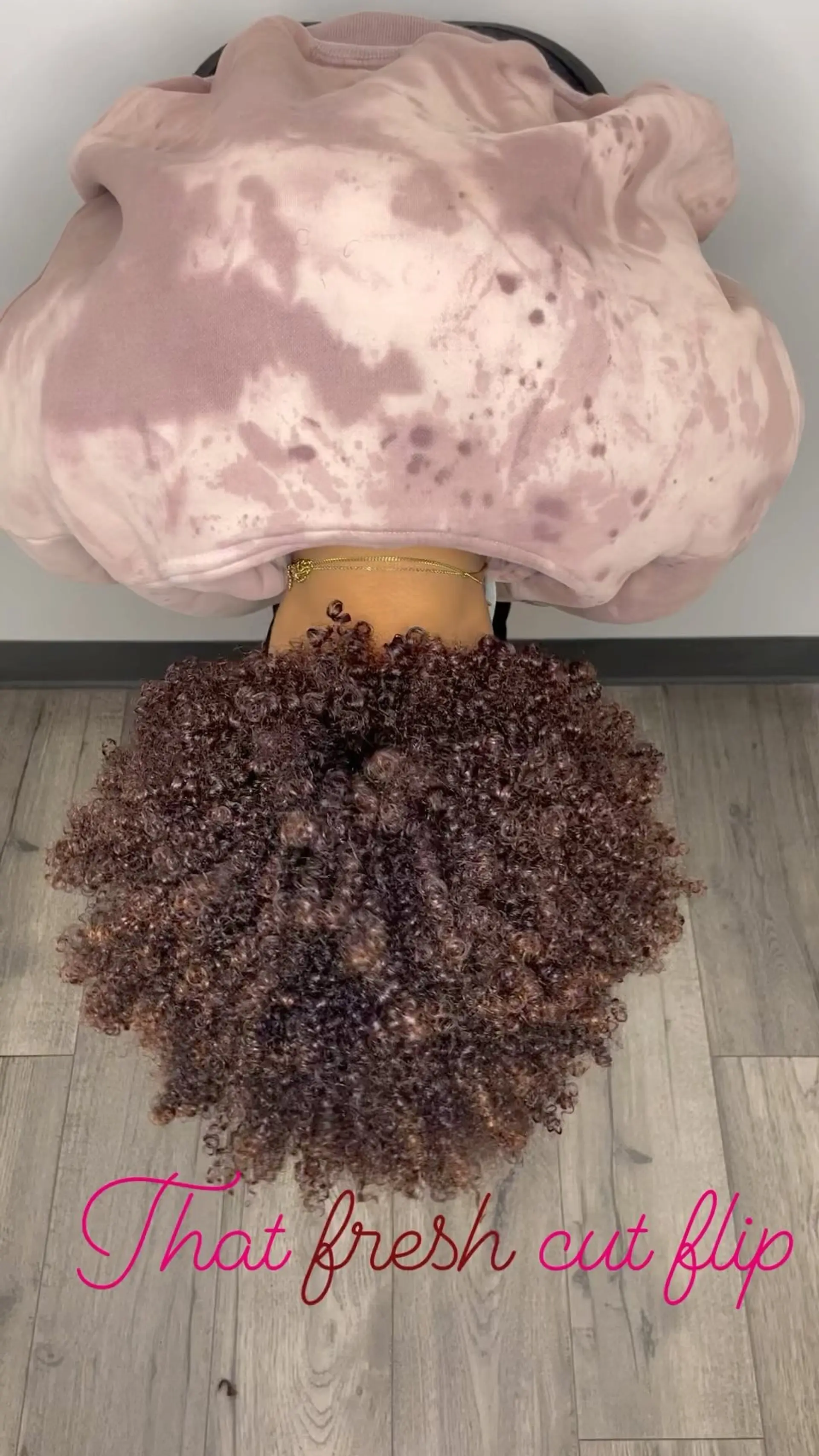 Voluminous, tightly coiled curls cut and shaped with defined texture and natural bounce. 1