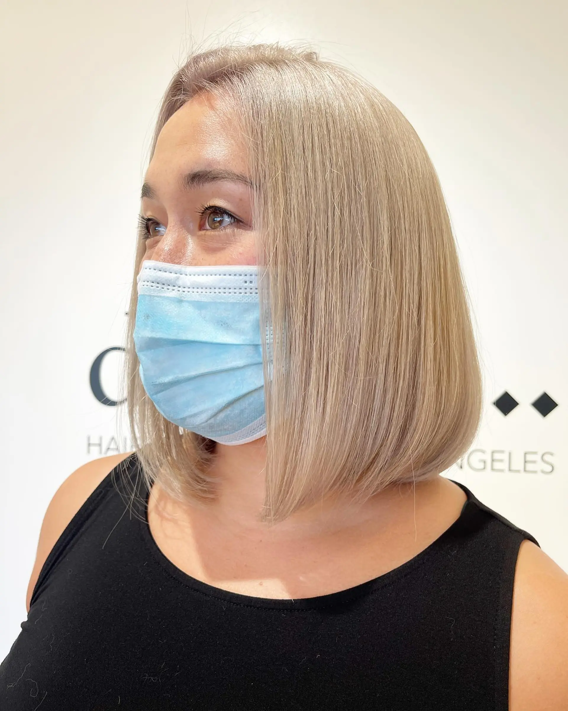 A sleek, shoulder-length blunt bob styled straight with softly tucked ends in a cool platinum blonde hue. 1
