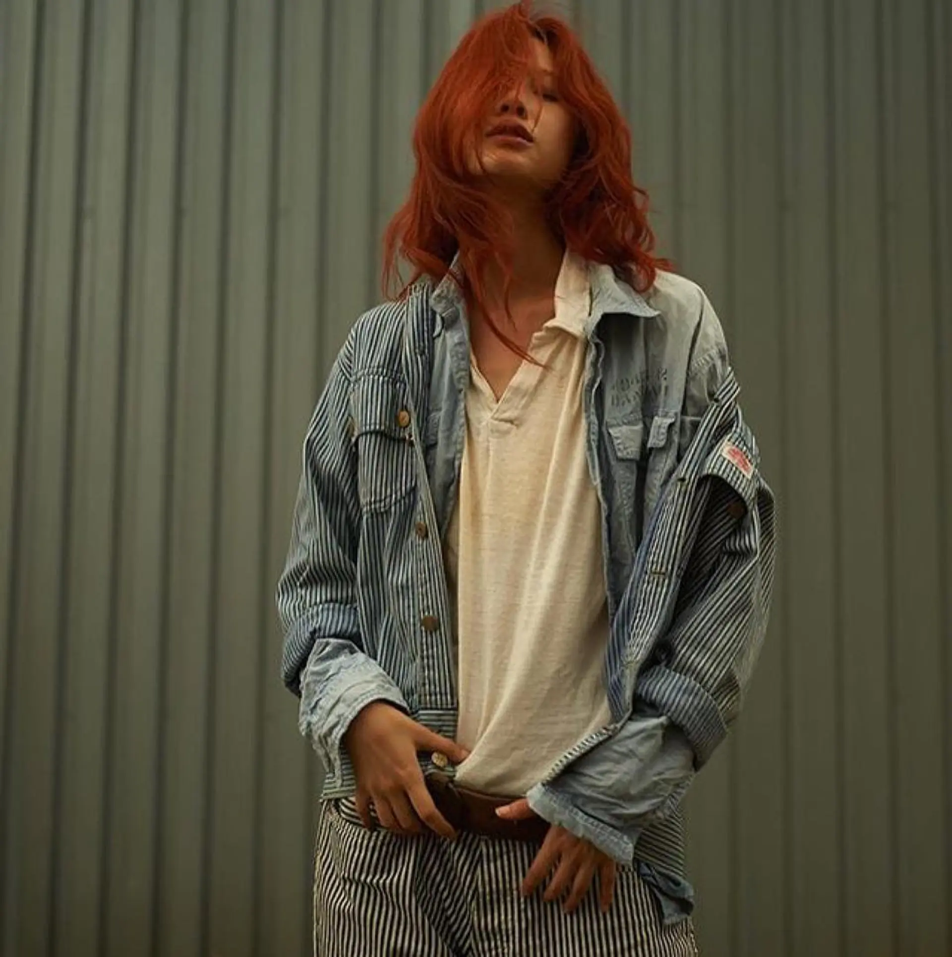 A vibrant copper mid-length hair look styled with tousled, undone waves and effortless texture. 1