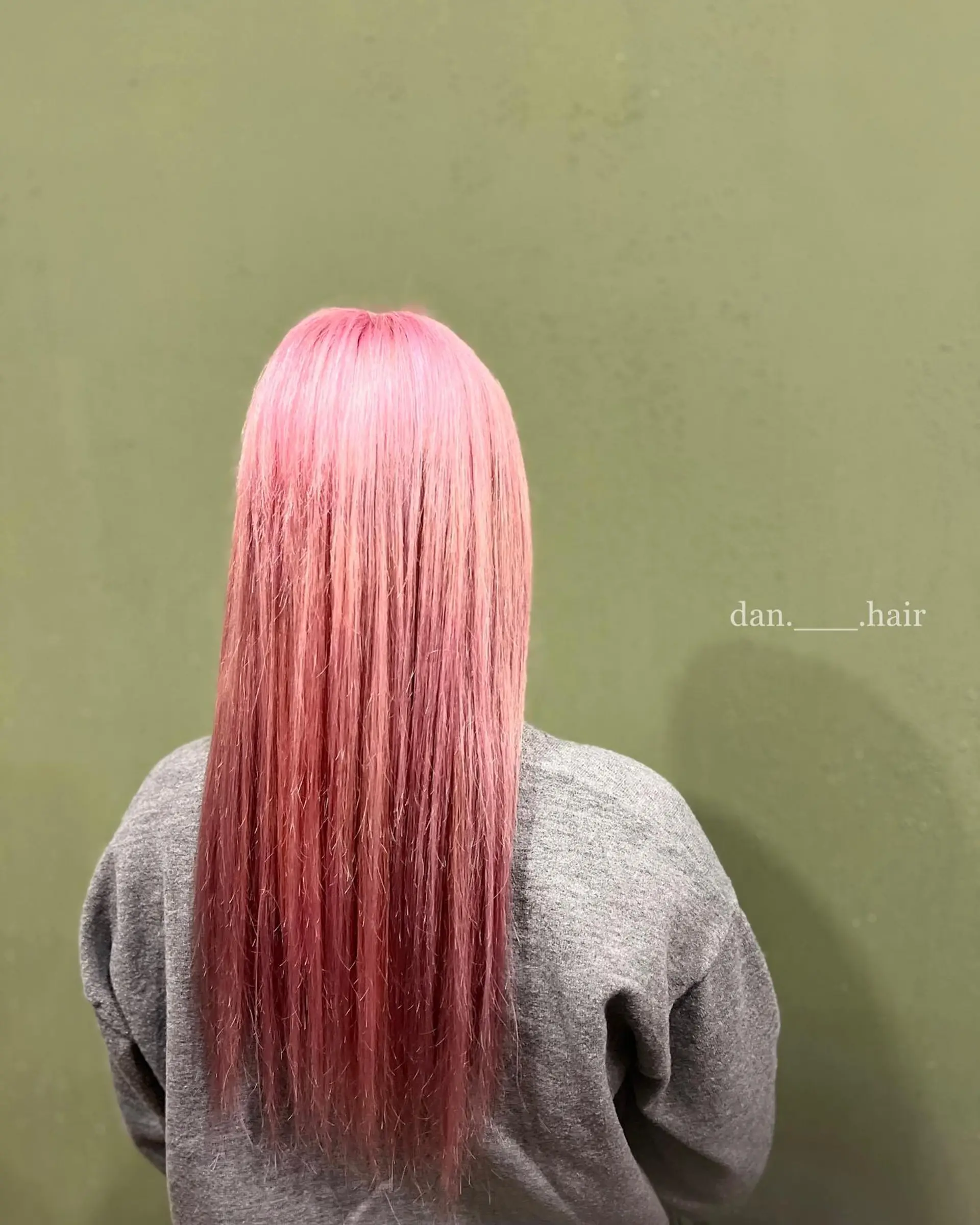 Long, sleek straight hair dyed in an all-over vibrant pastel pink shade. 1