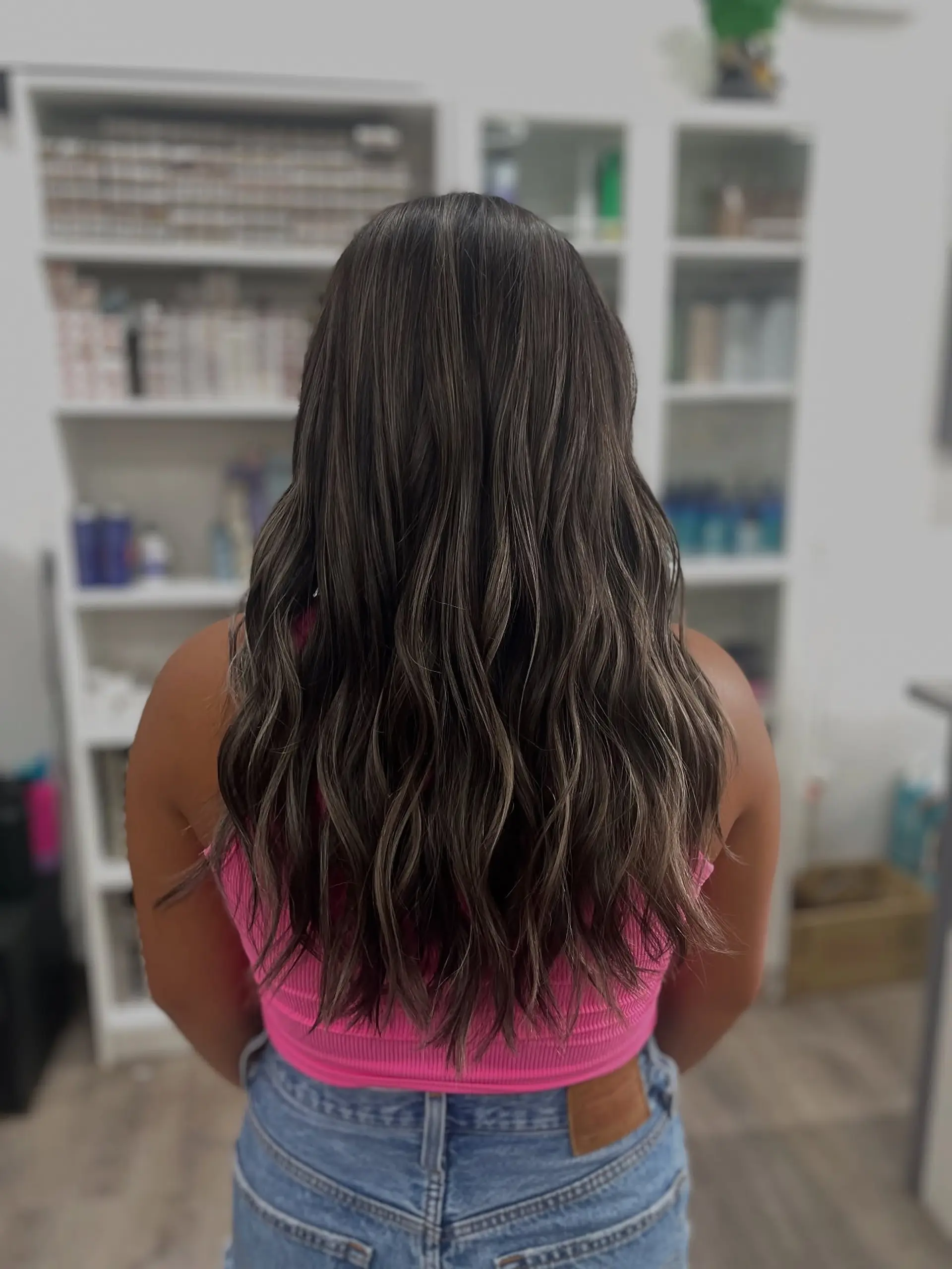 Long, wavy brunette hair with subtle balayage highlights and subtle layers. 1