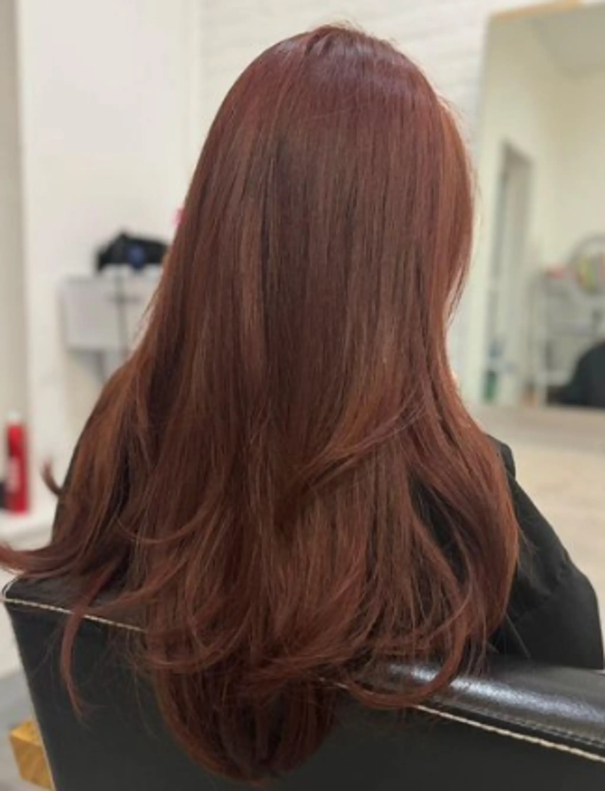 Long, straight red hair with subtle layers, creating a smooth and elegant appearance.
