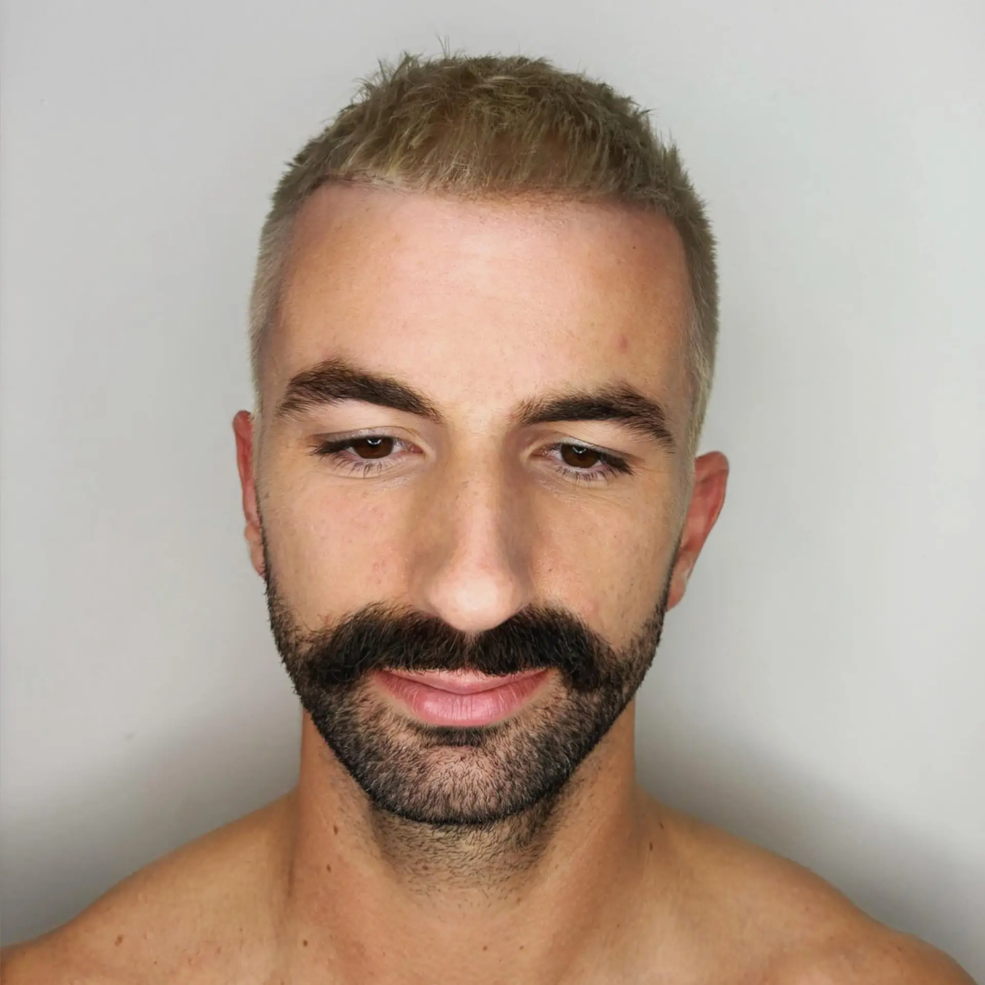 A textured short crop featuring an all-over cool ash blonde color. 1