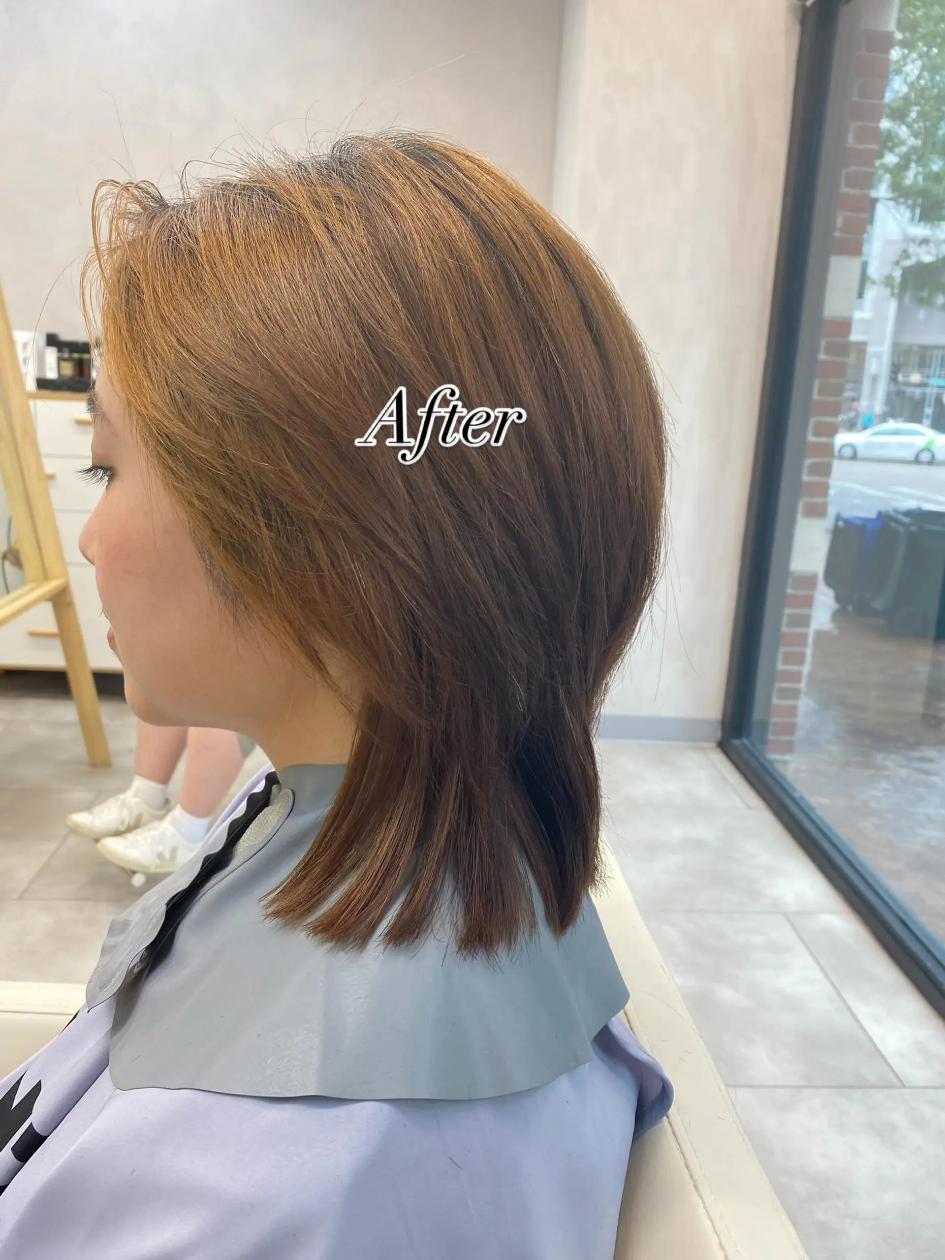A textured shoulder-length cut featuring soft interior layers and piecey ends in a warm golden brown shade. 1