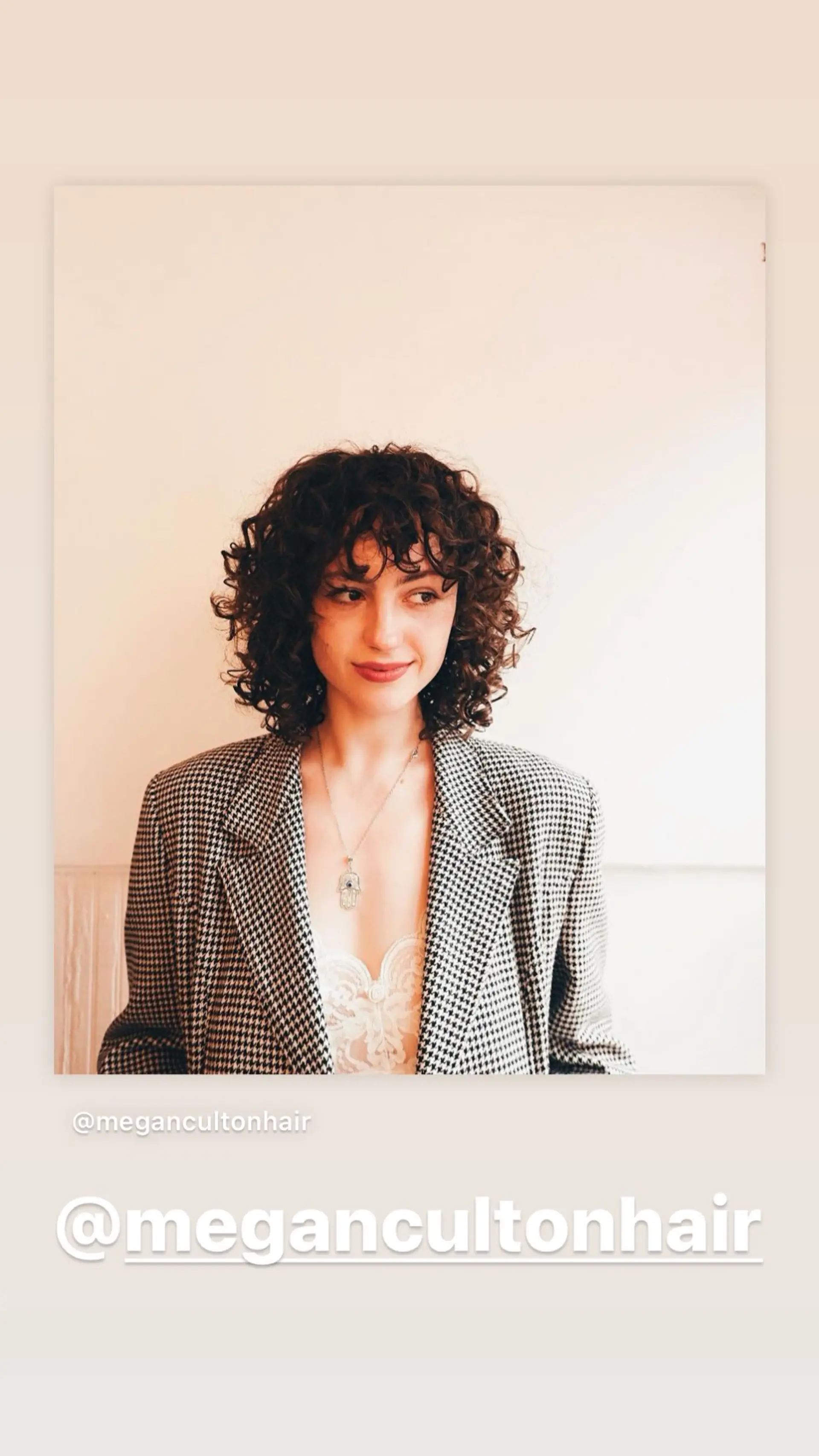 A textured curly bob with face-framing bangs. 1