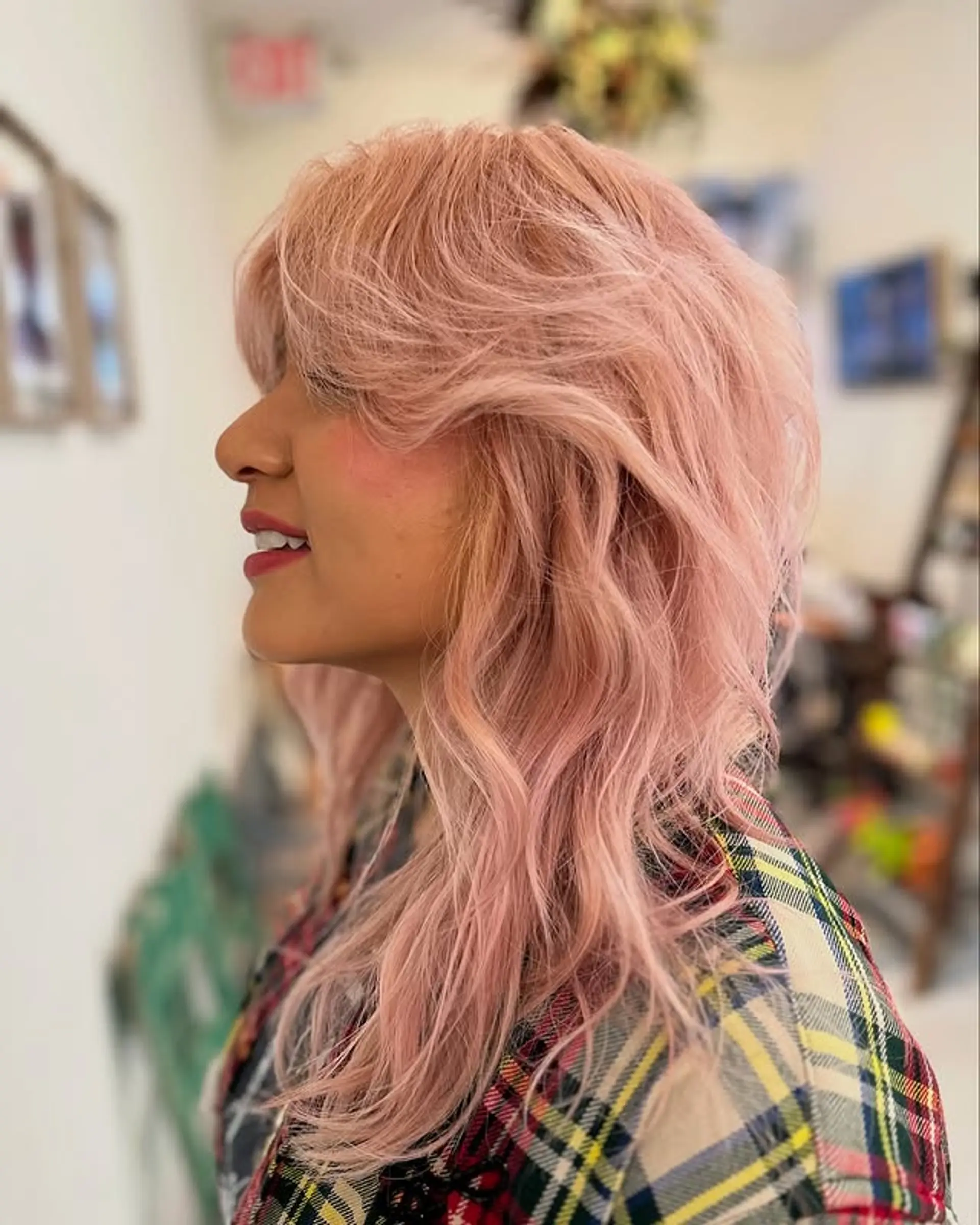 A shaggy, medium-length hairstyle with textured waves and face-framing curtain bangs. 1