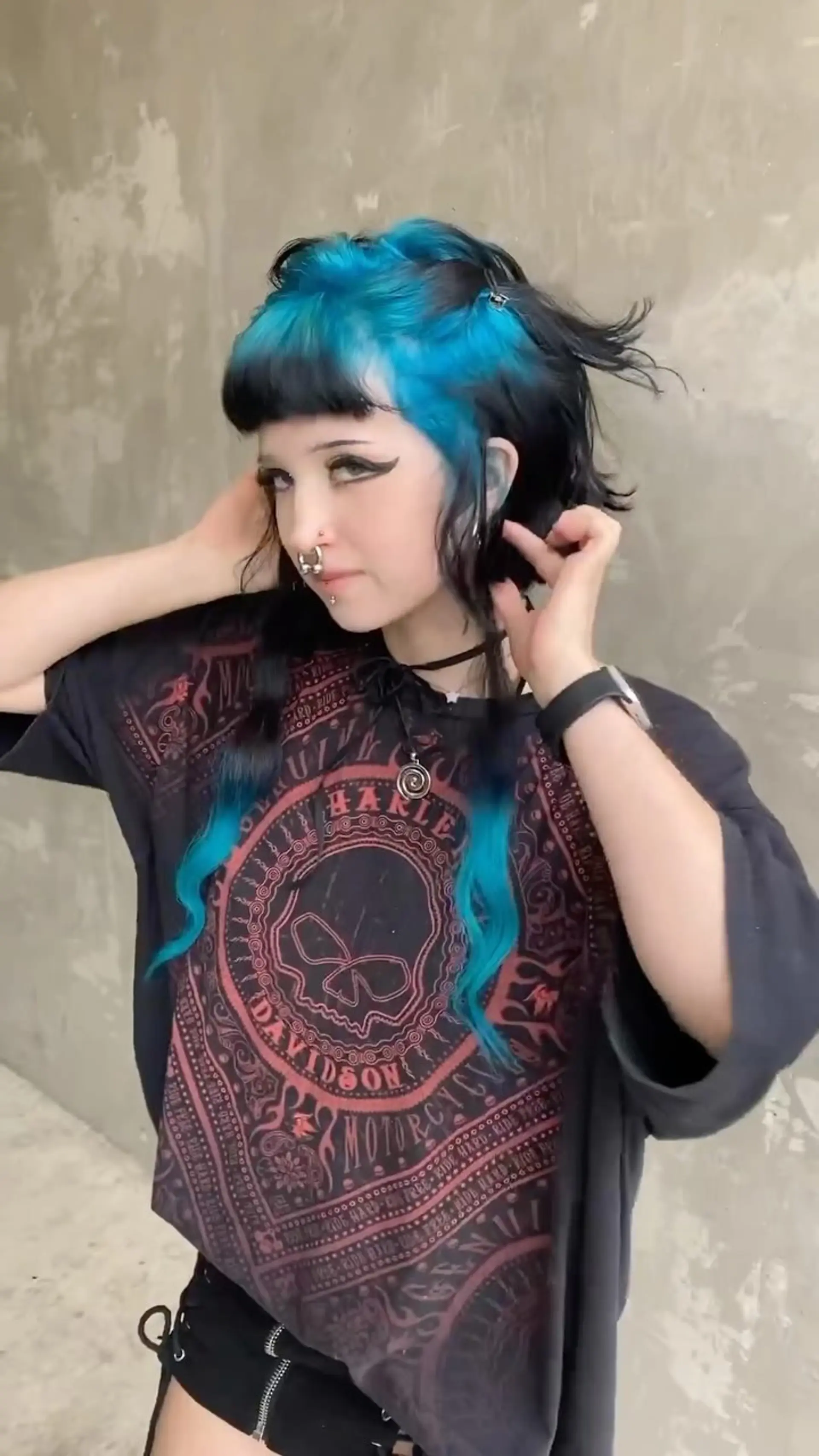 Alternative two-tone mullet style featuring bright cyan-blue crown roots contrasted with black textured layers and long blue front tendrils with micro bangs. 1