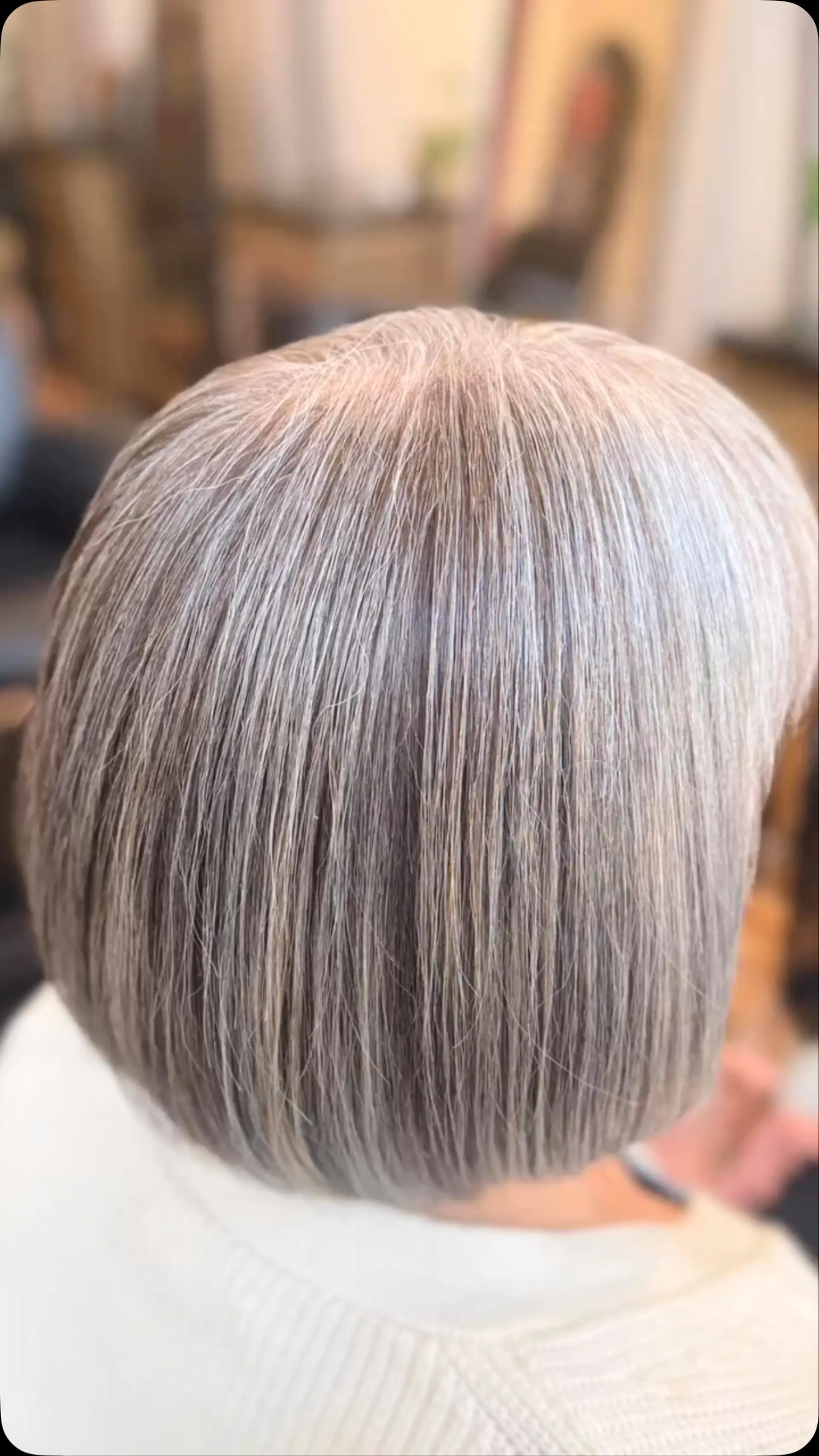A sleek, rounded short bob featuring fine grey blending and dimensional silver tones. 1