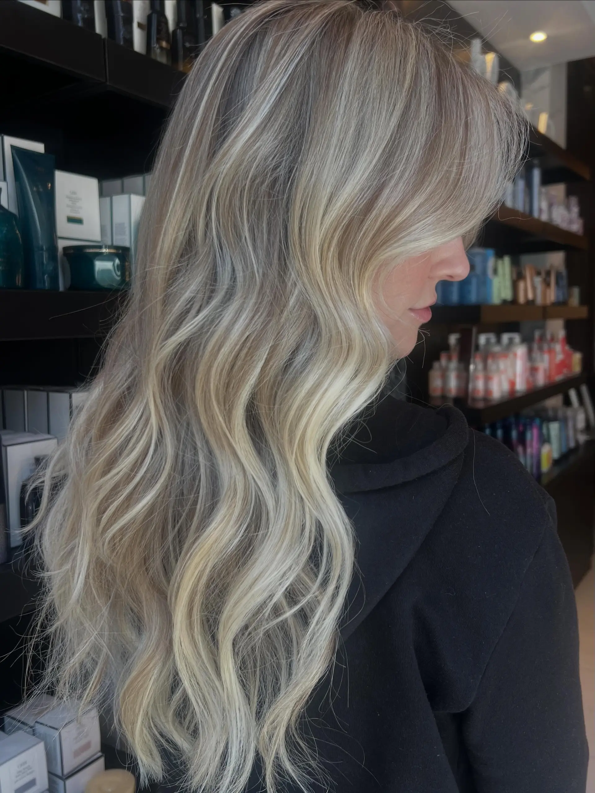 Long, flowing blonde hair styled in soft, loose waves featuring seamless, dimensional baby blonde highlights. 1