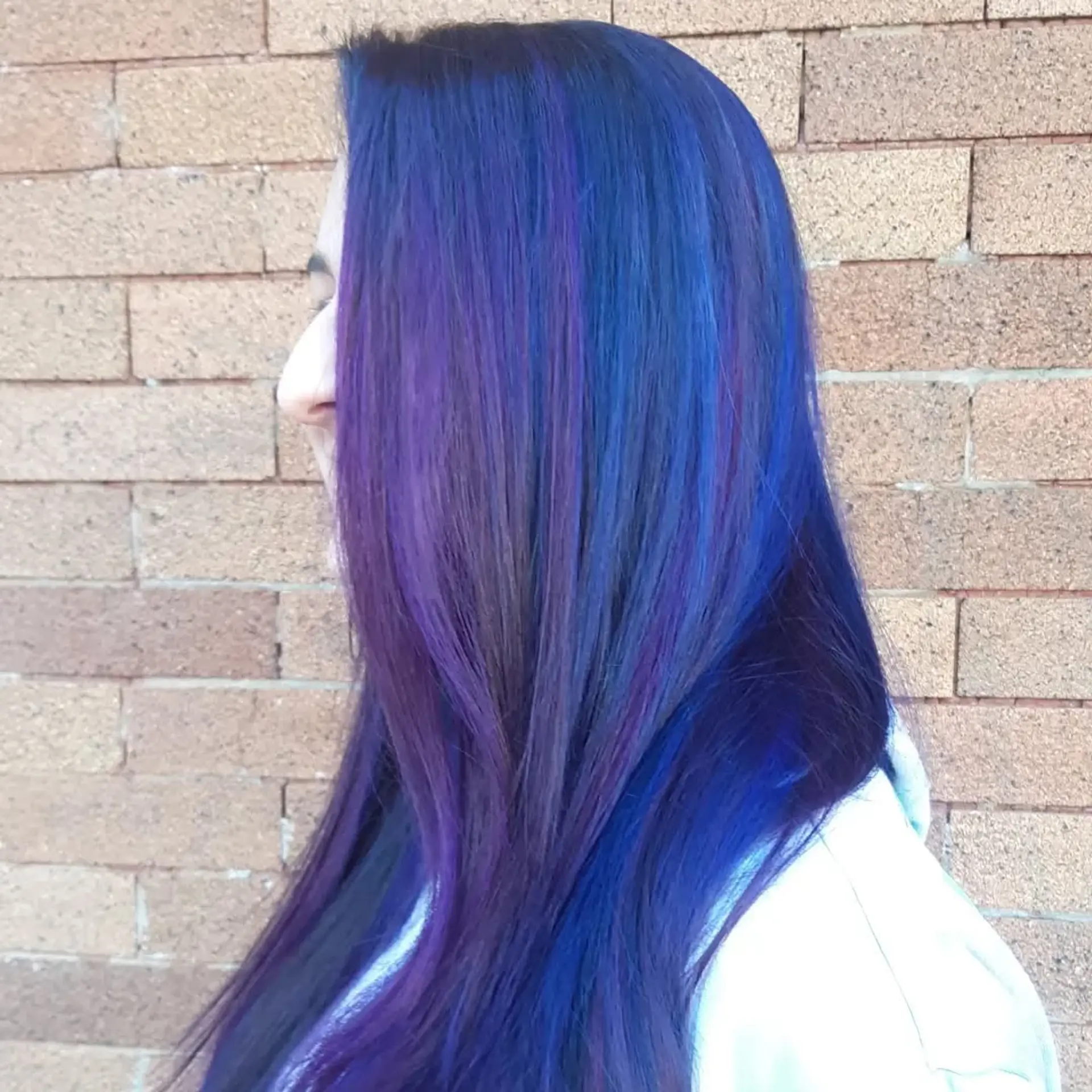 Long layered hairstyle featuring a mix of vibrant blue and purple hues. 1