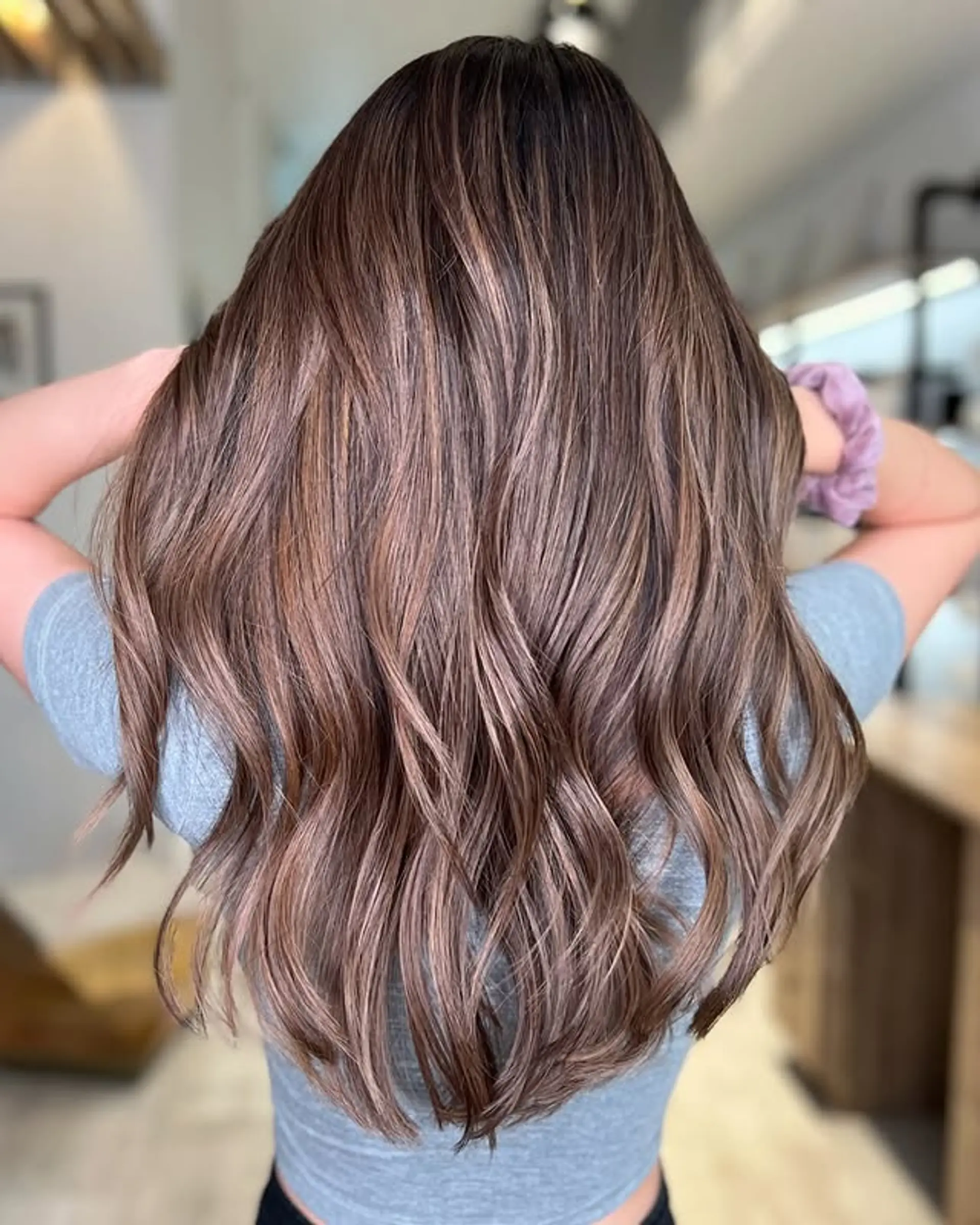 A long, wavy hairstyle with a bronzed balayage. 1