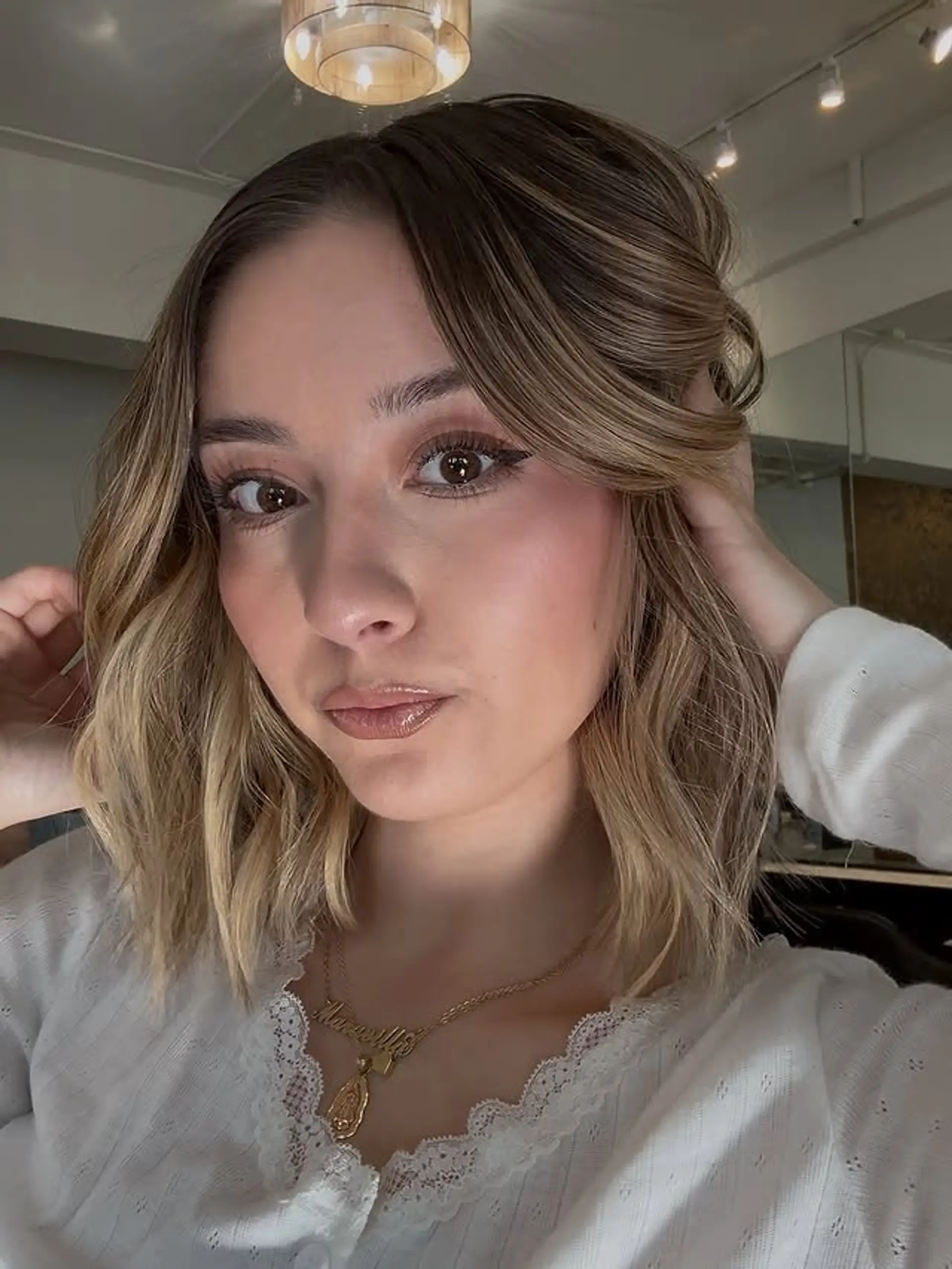 A trendy, wavy bob with bronde balayage and face-framing layers for a stylish and effortless appearance. 1