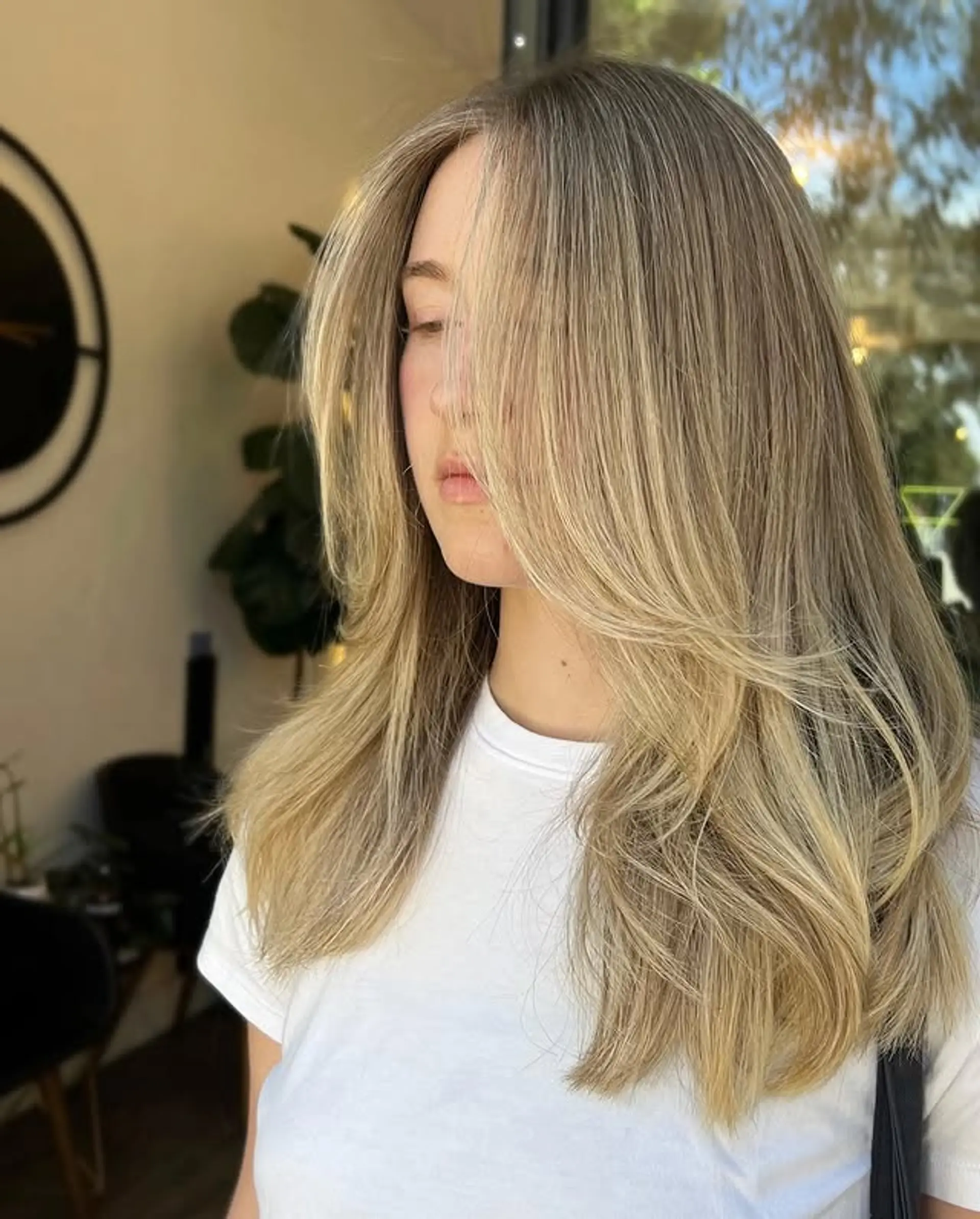 Long layered hair with curtain bangs and soft waves. 1