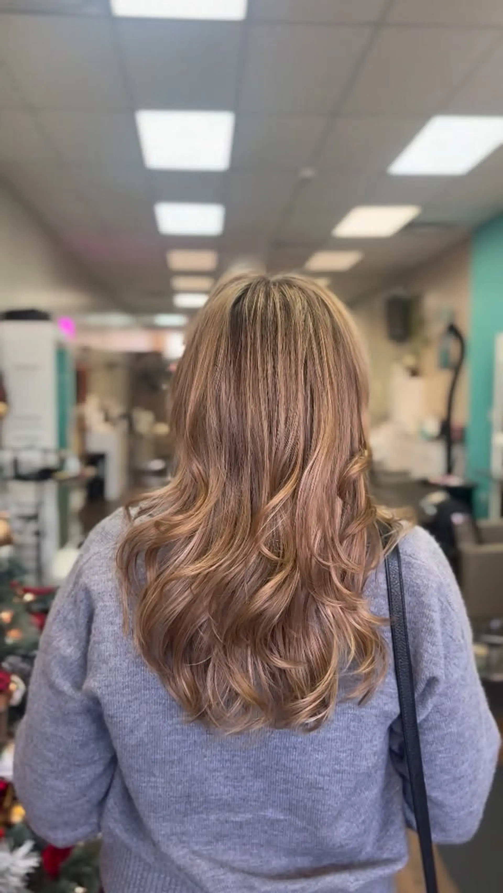 Long honey blonde balayage hair styled smooth at the crown with soft, loose waves through the ends. 1