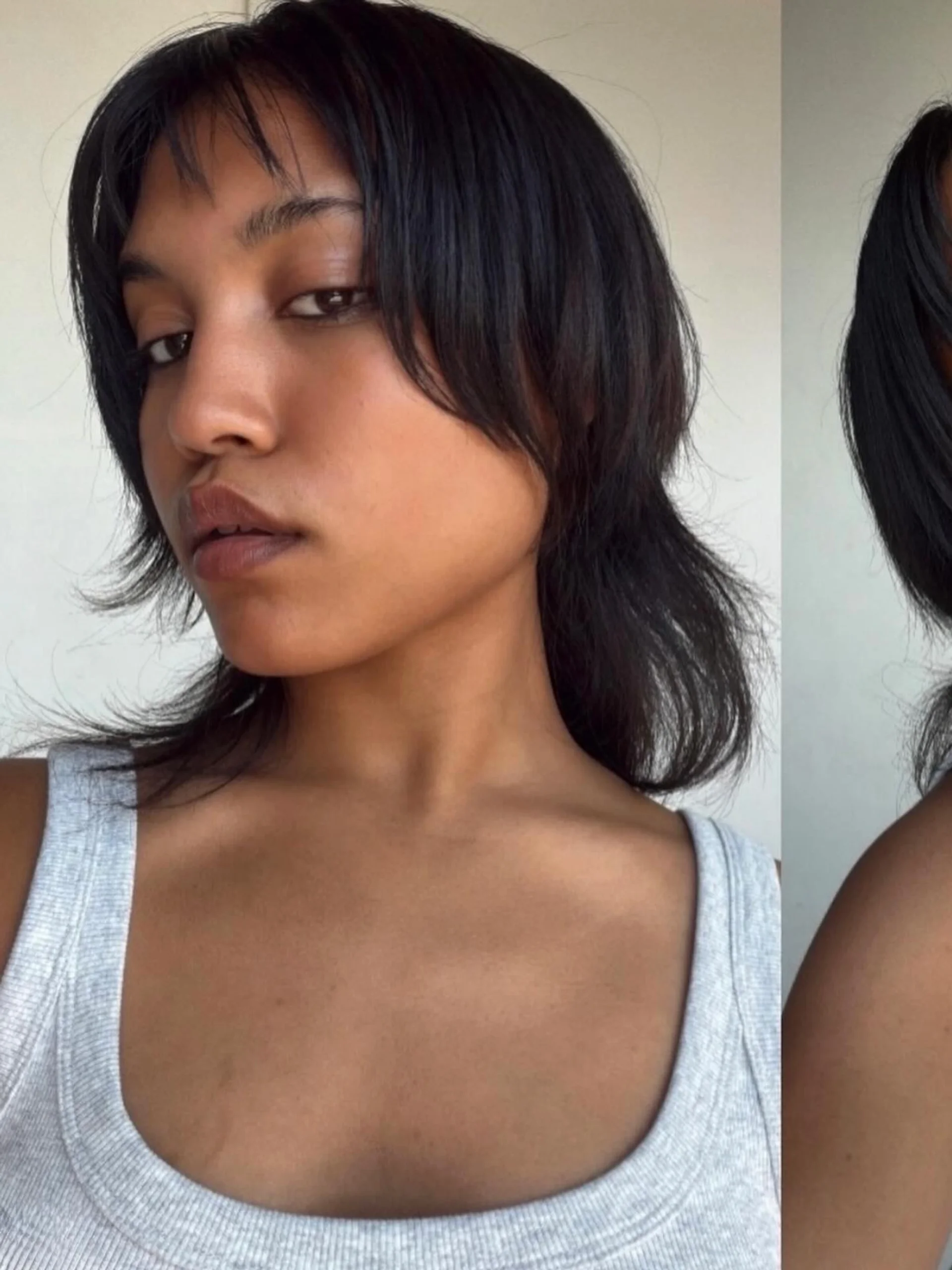 A person with wavy, medium-length teal hair cut into a shag with fringe bangs. - Preview 1