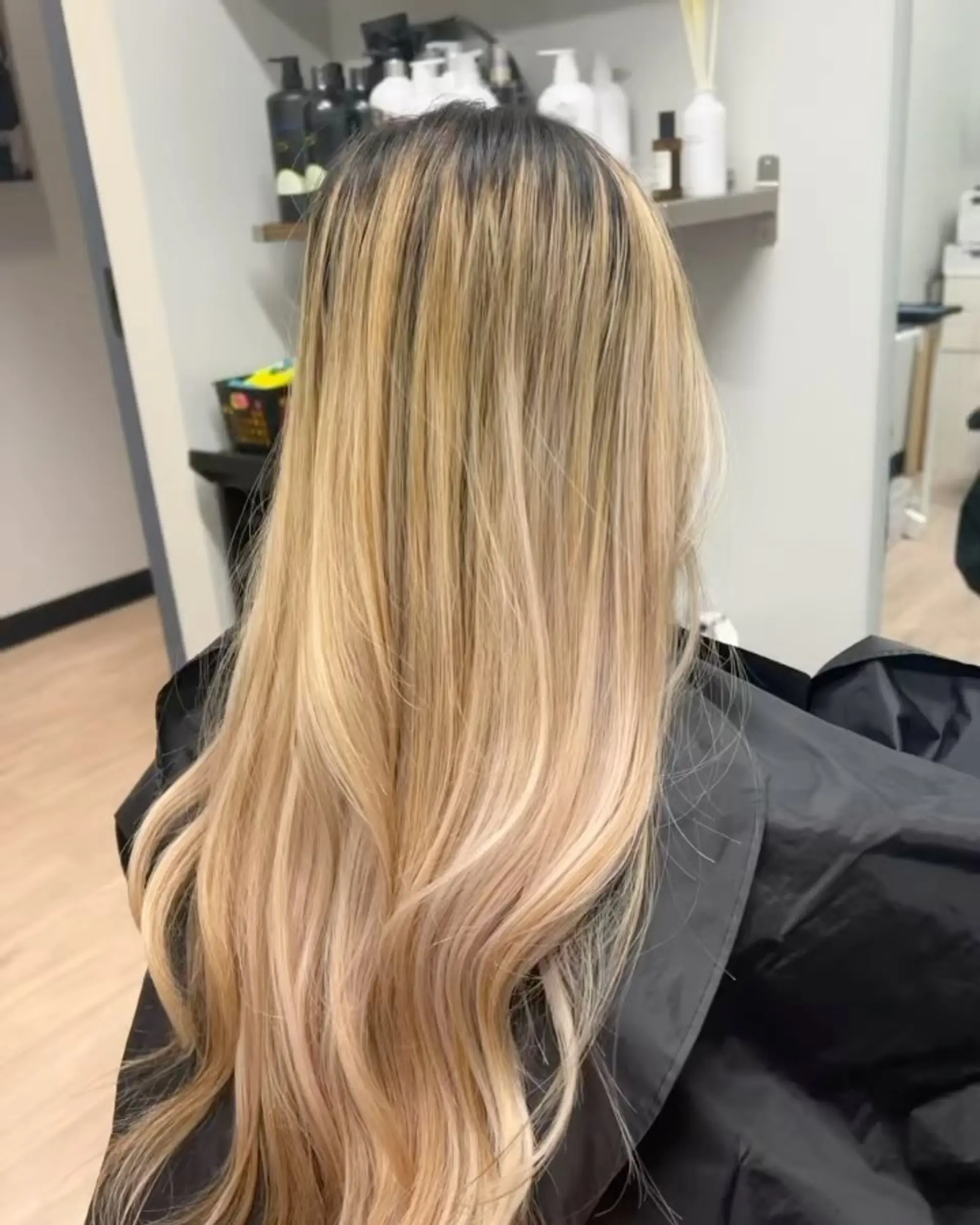 Long blonde balayage with smooth, sleek texture and a natural dark shadow root. 1