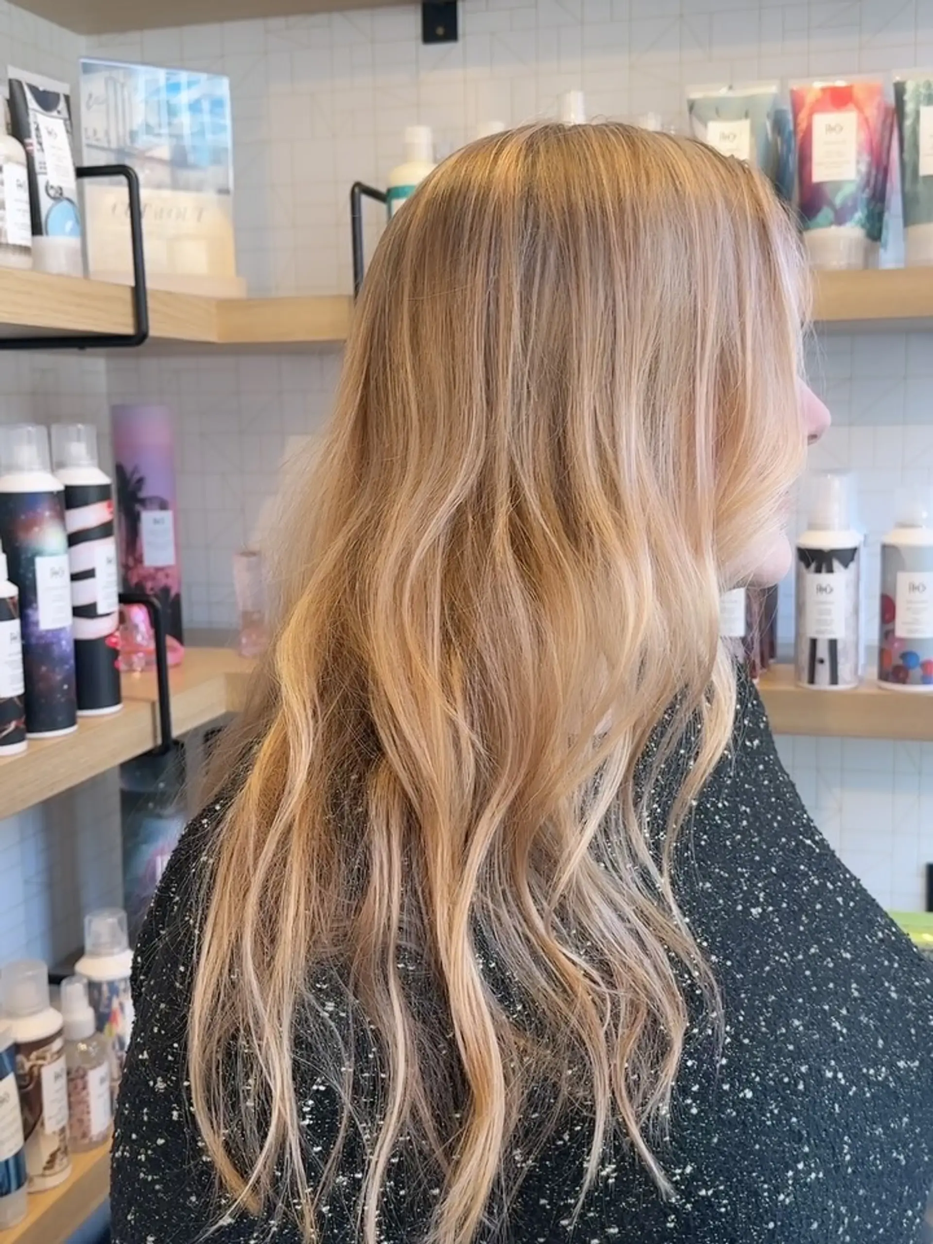 Long warm golden blonde hair styled into effortless, soft waves. 1