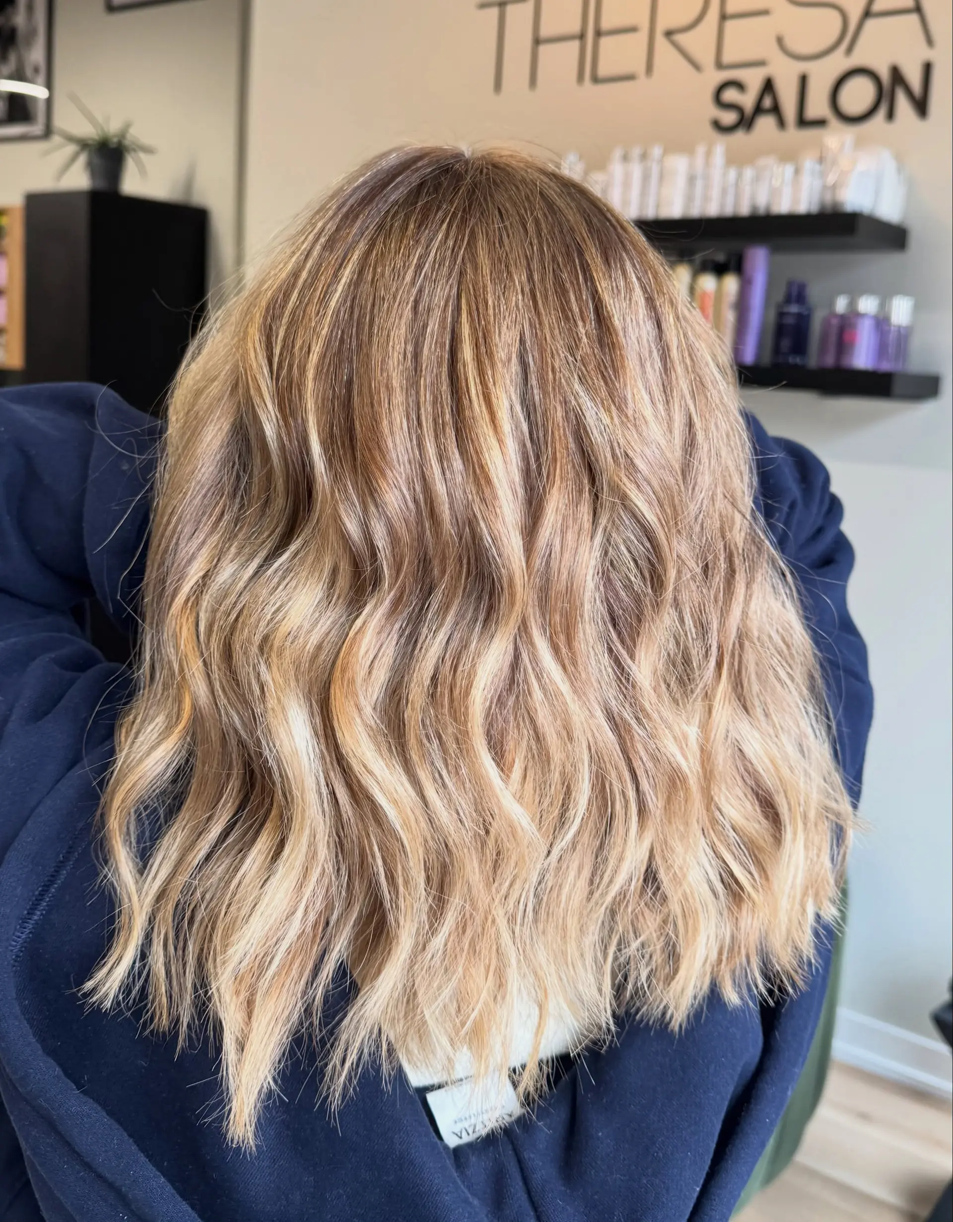 Medium-length hair with golden blonde balayage highlights styled in soft, beachy waves. 1