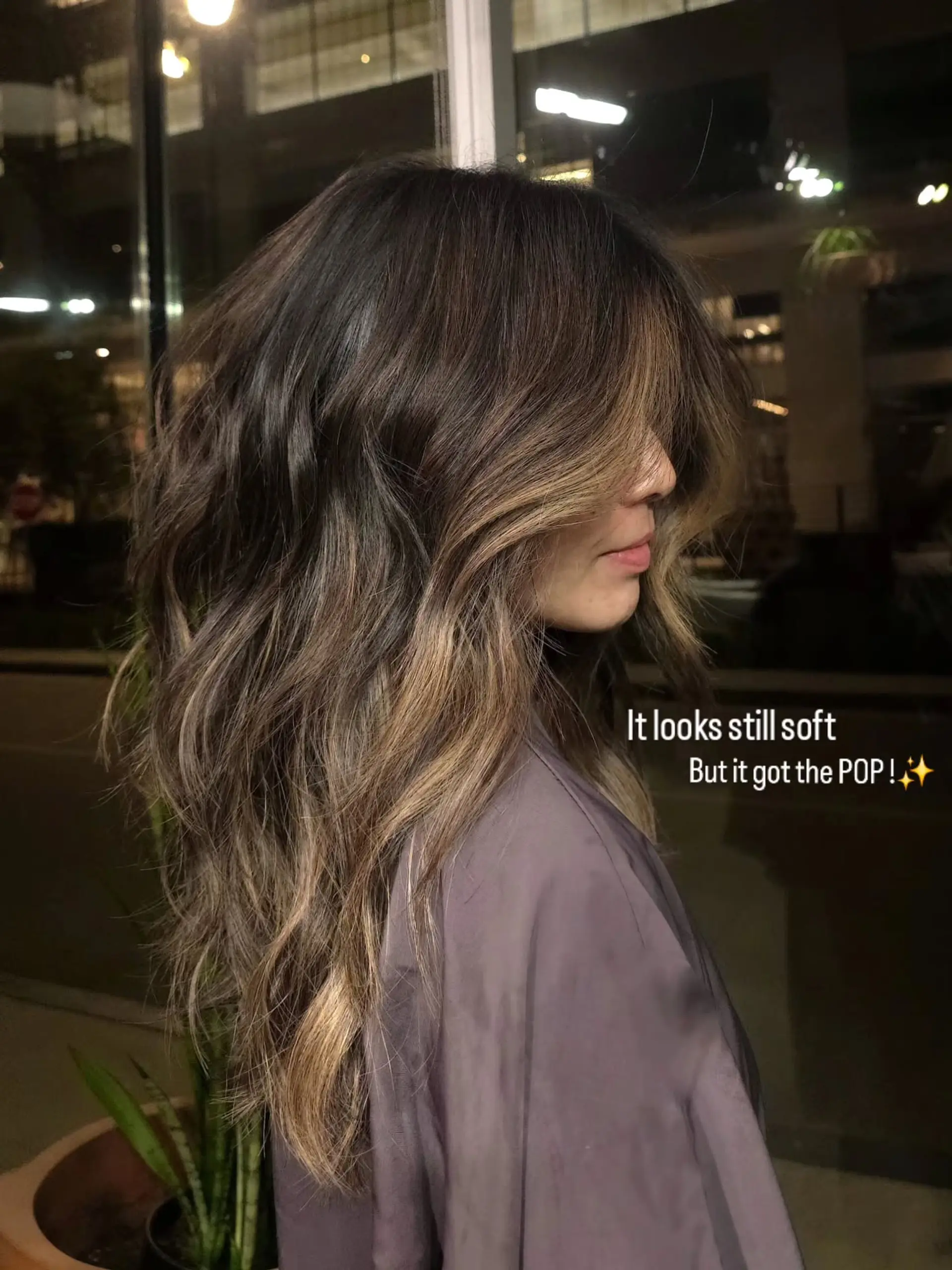 Long dimensional bronde hair featuring soft, face-framing balayage highlights styled in loose, lived-in waves. 1