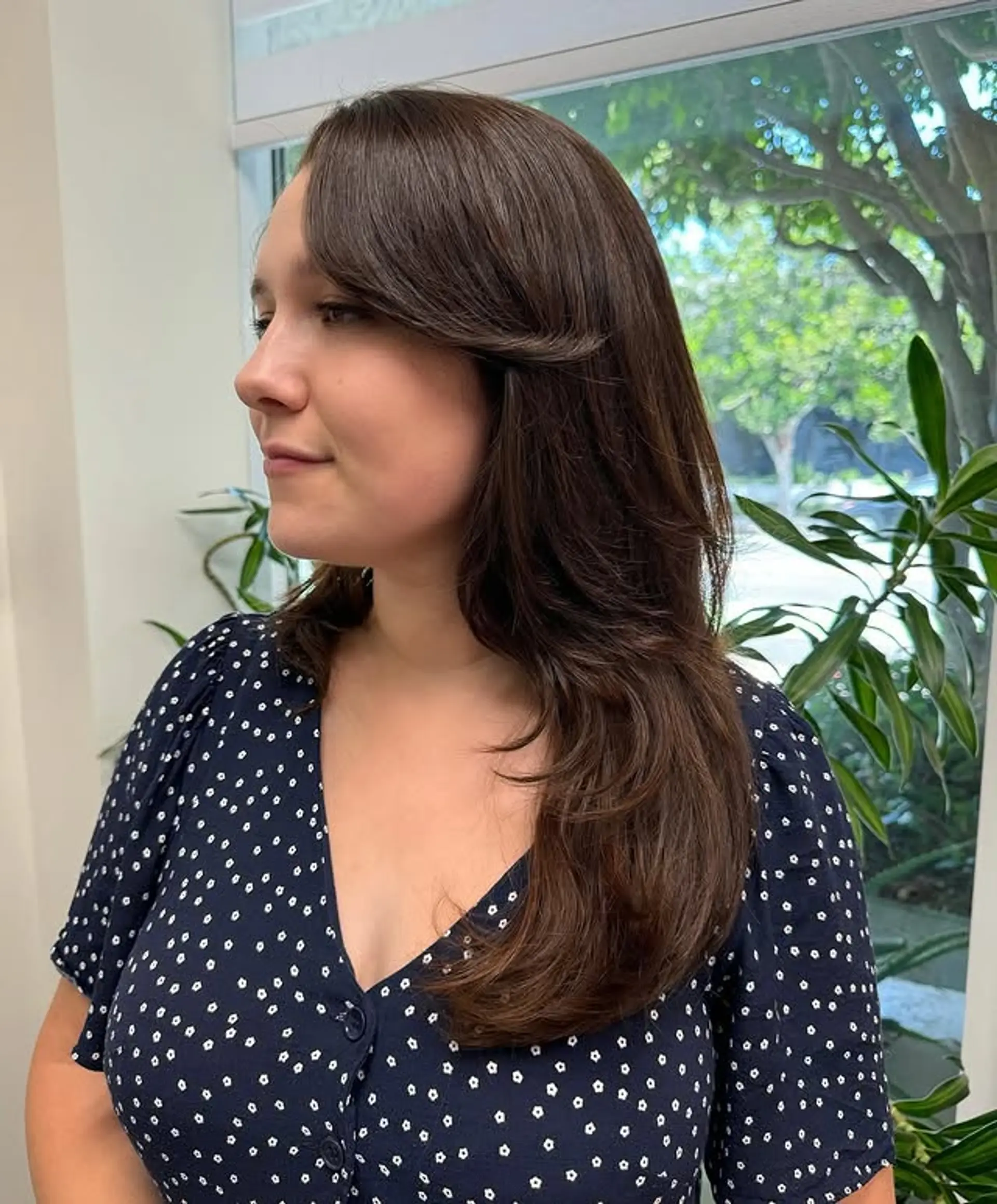 A long layered hairstyle featuring face-framing curtain bangs. 1