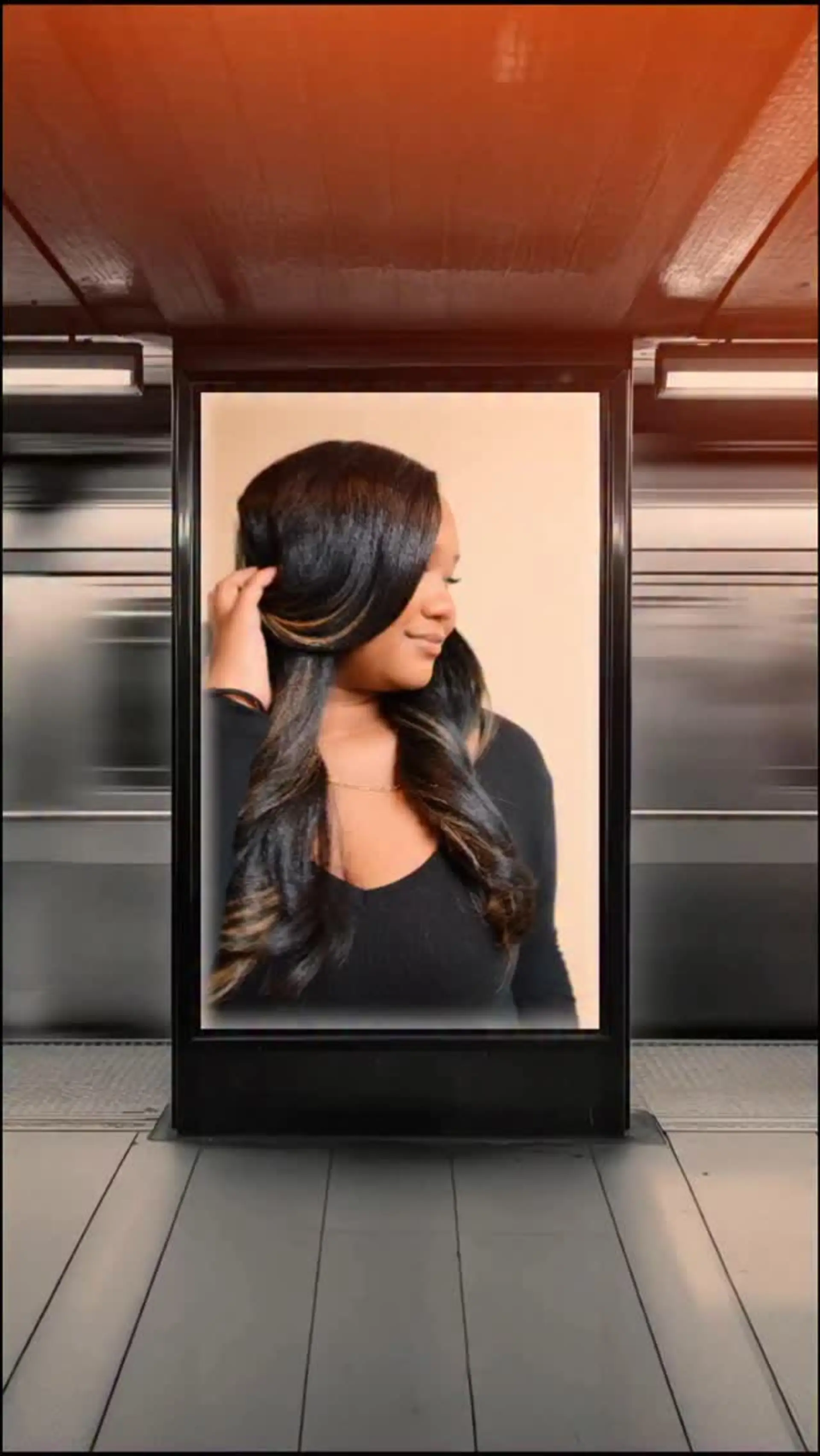 Long, dark hair featuring subtle caramel highlights, styled into sleek, soft body curls. 1