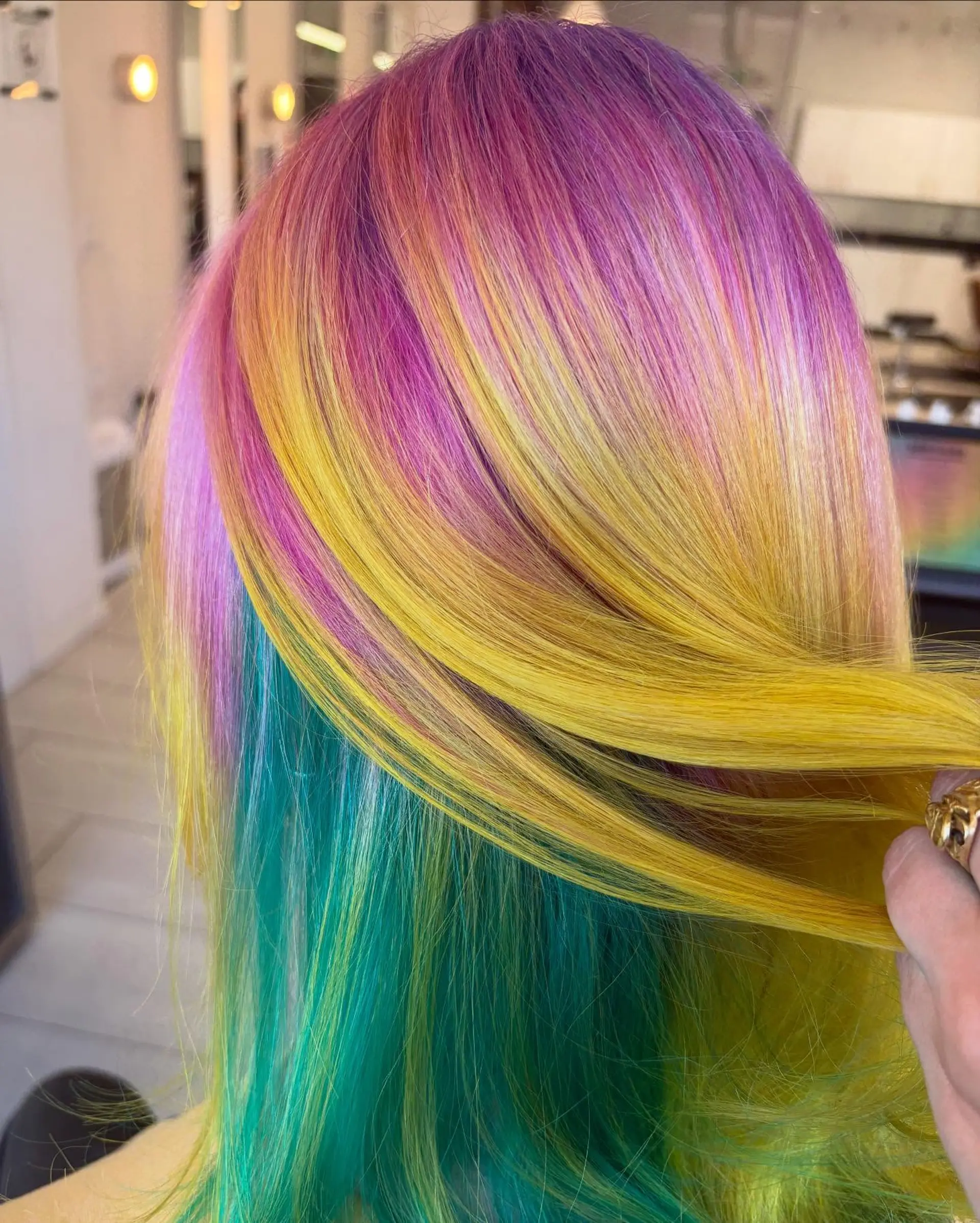 Straight medium-length hair showcasing an intricate vivid color design with purple, pink, bright yellow, and teal tones. 1