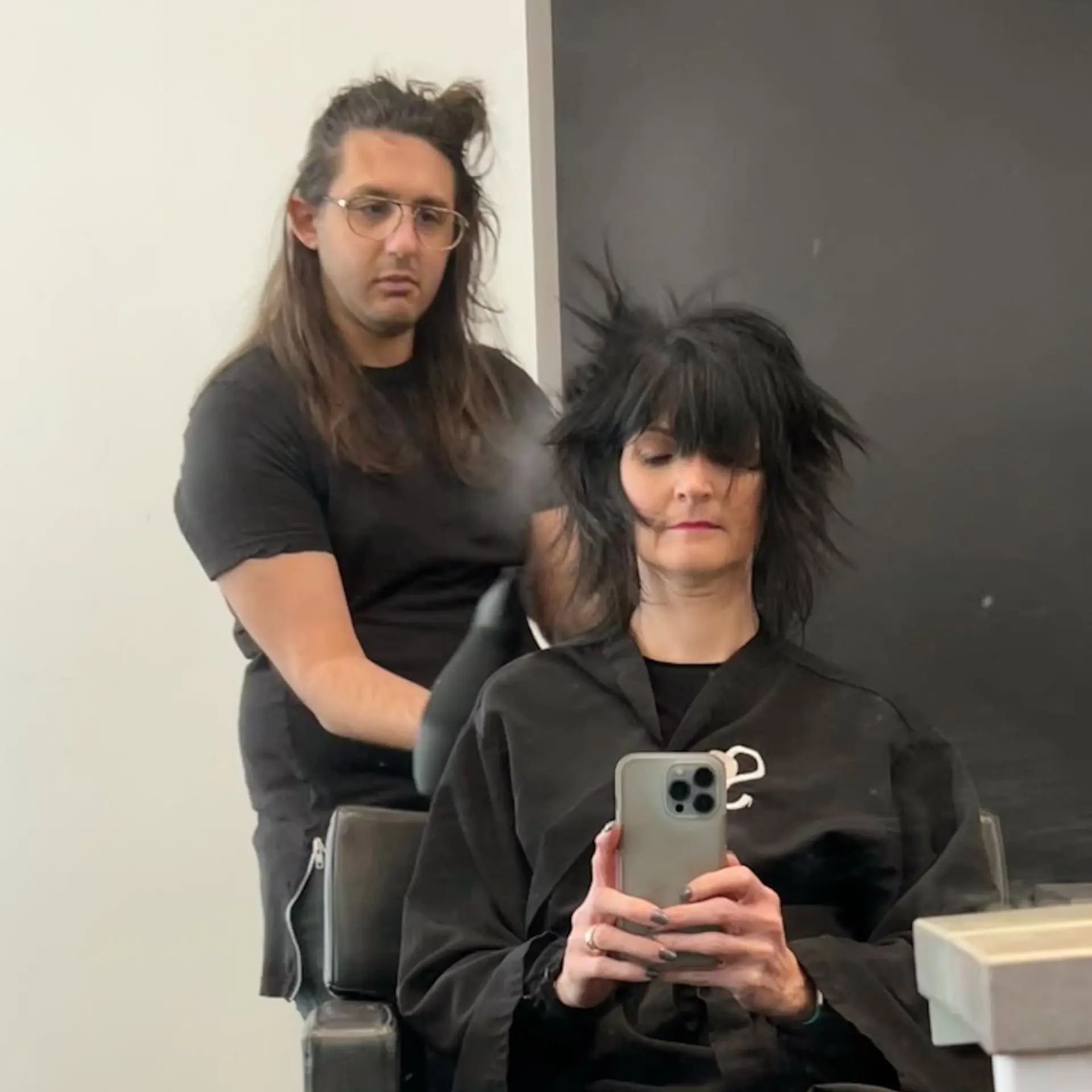 A textured black shag haircut with face-framing fringe and heavily feathered layers. 1