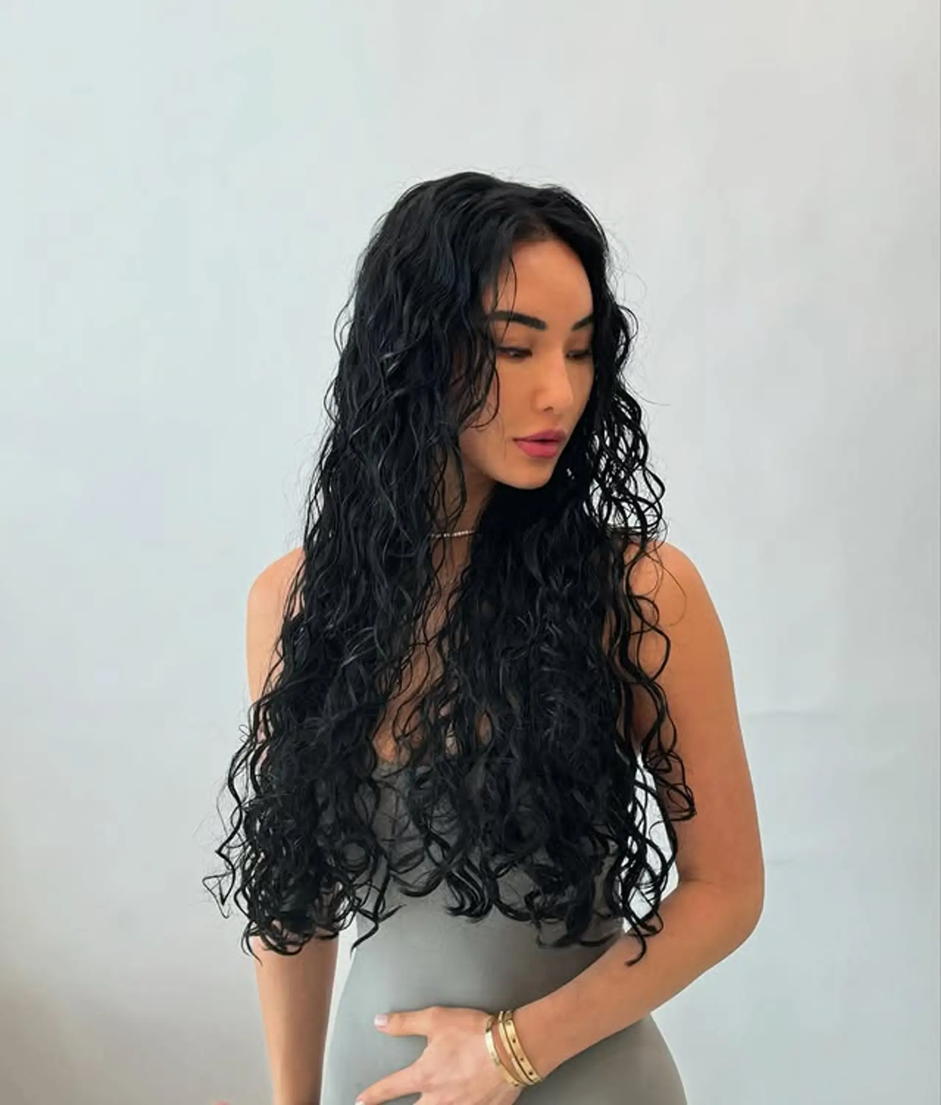 Long, wavy hairstyle with a wet look finish. 1