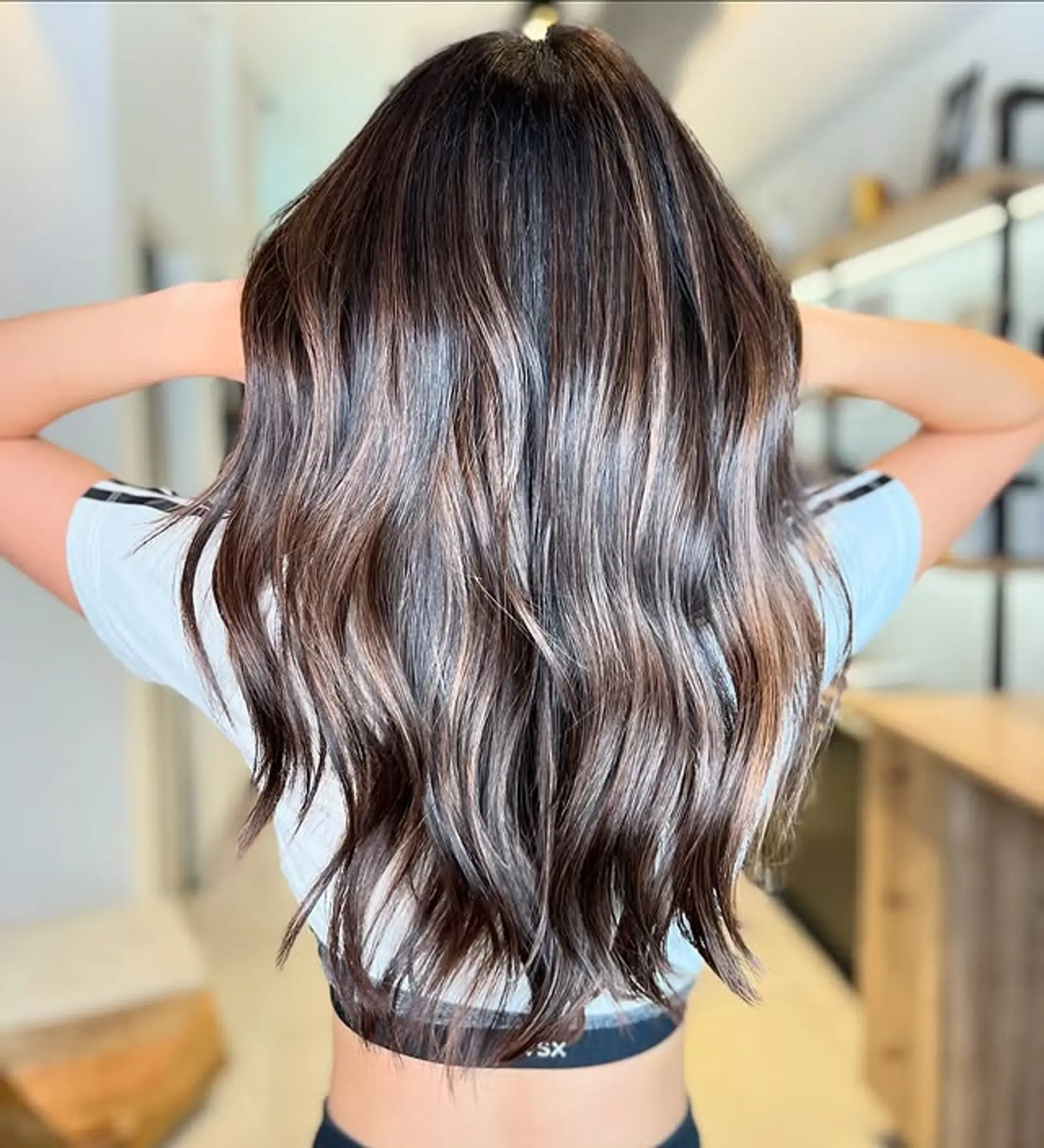 Long wavy hair with a chocolate brown balayage and blonde highlights. 1