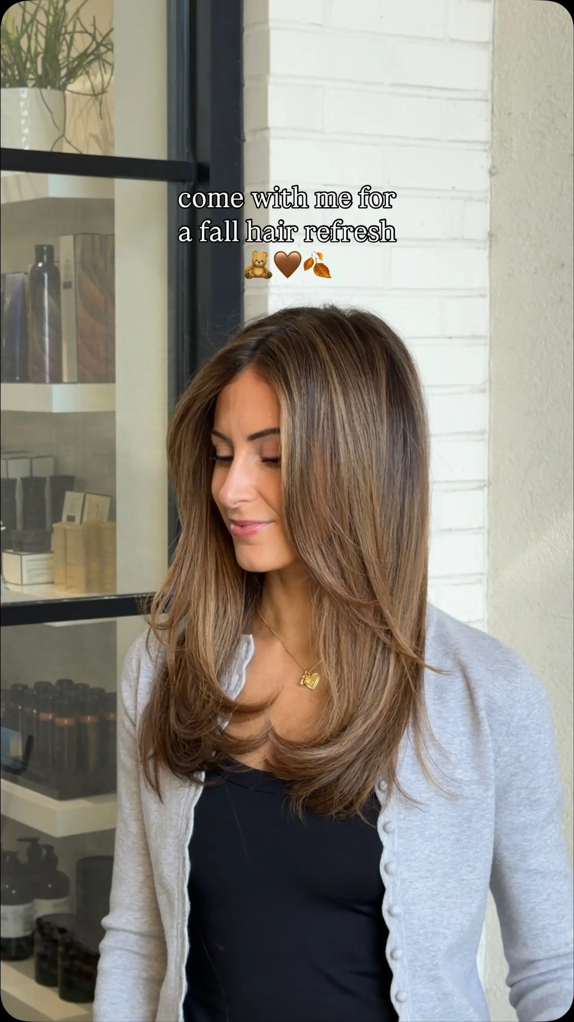 Long dimensional brunette hair styled in bouncy face-framing layers with smooth, curled-under ends. 1