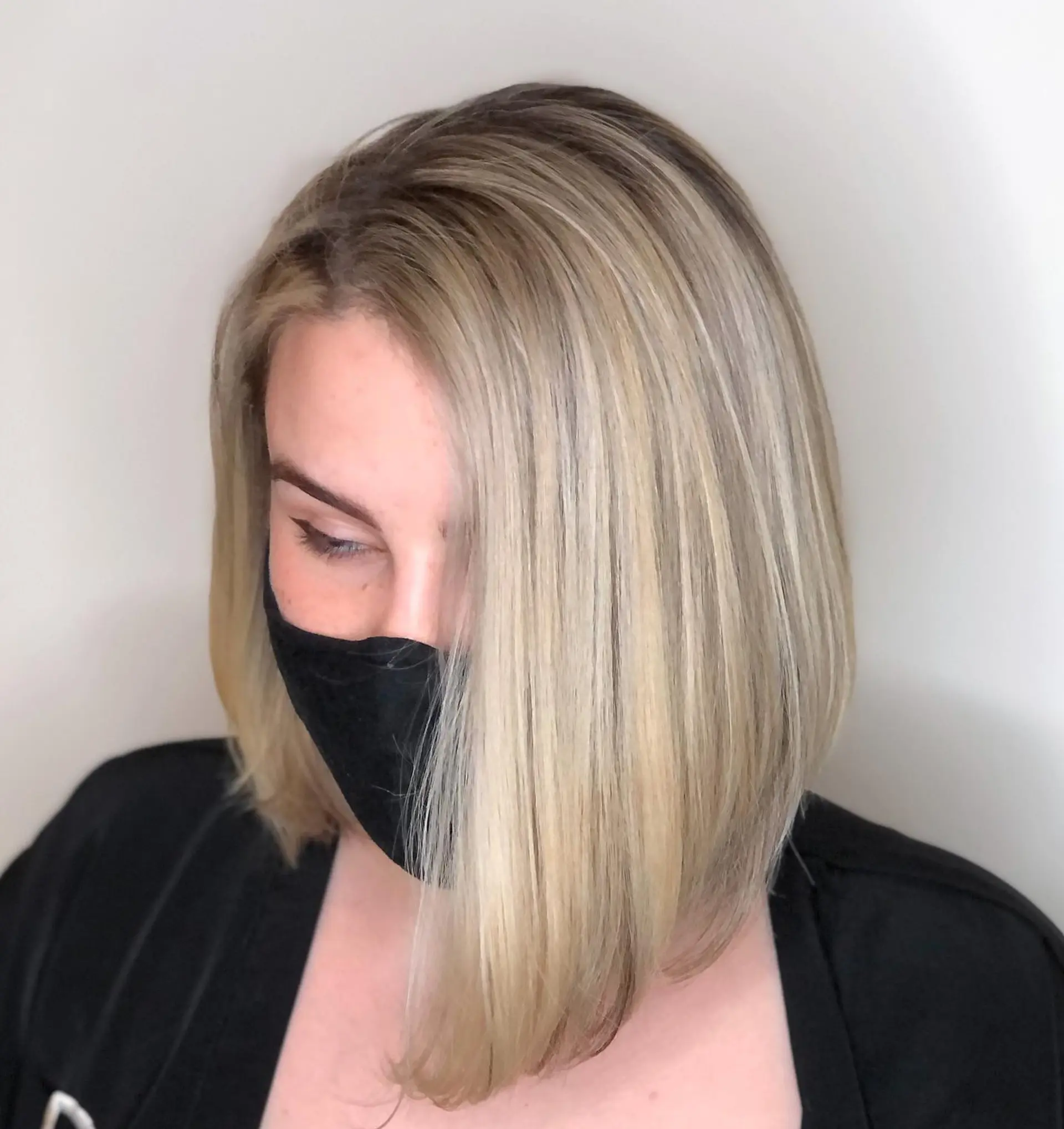 A sleek, smooth angled bob with cool ash blonde highlights and soft dimension throughout. 1