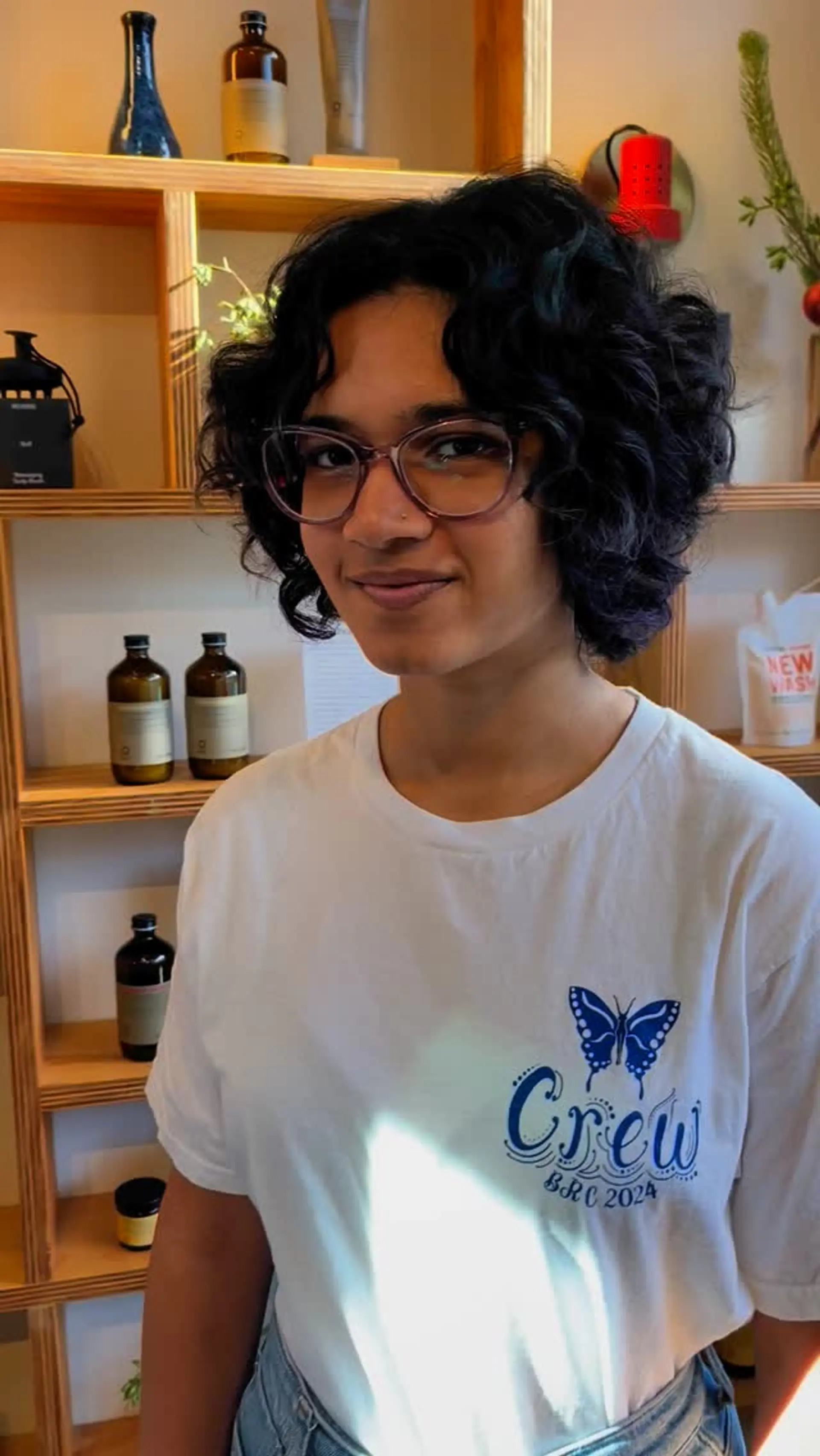 A layered short cut showcasing voluminous, natural curls framing the face. 1