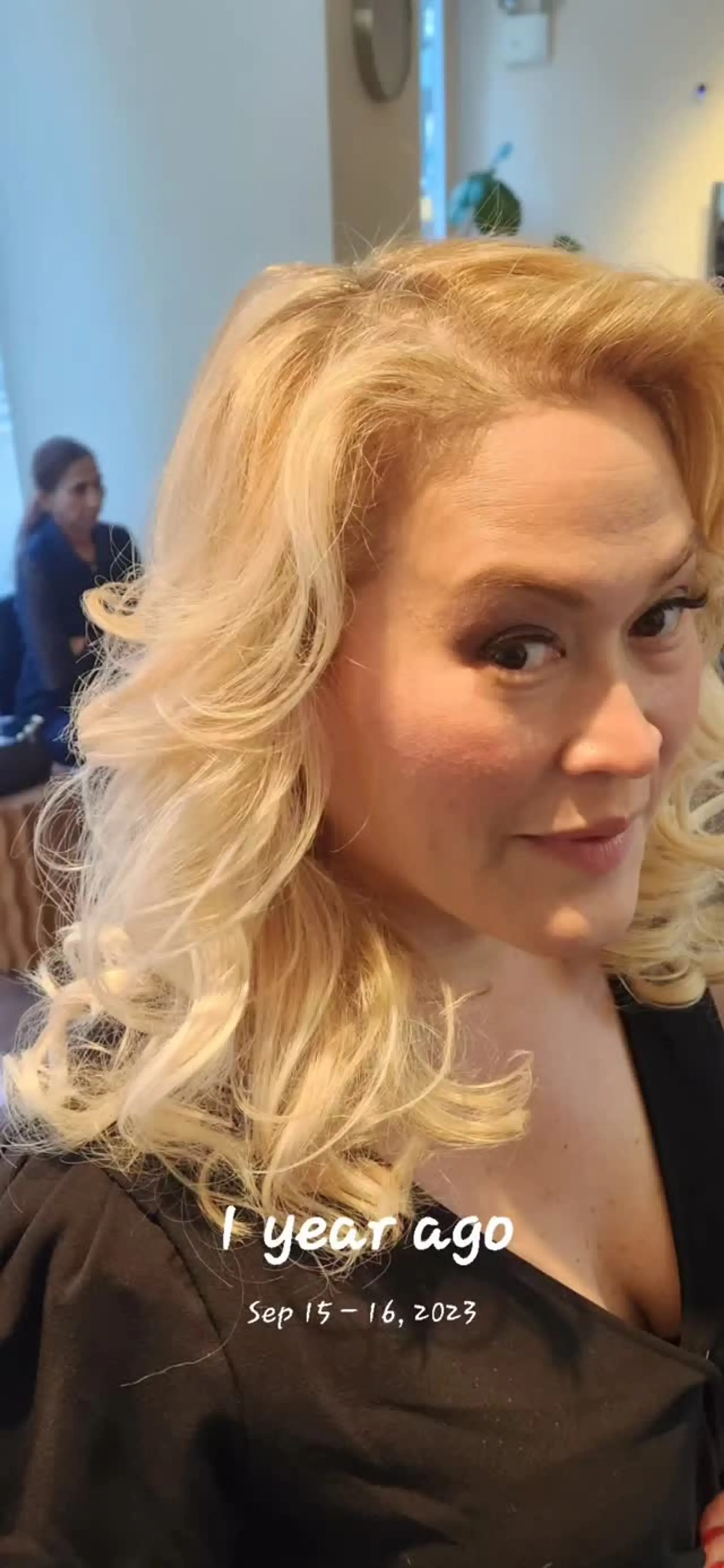 A voluminous, layered blonde blowout styled with sweeping, soft curls around the shoulders. 1