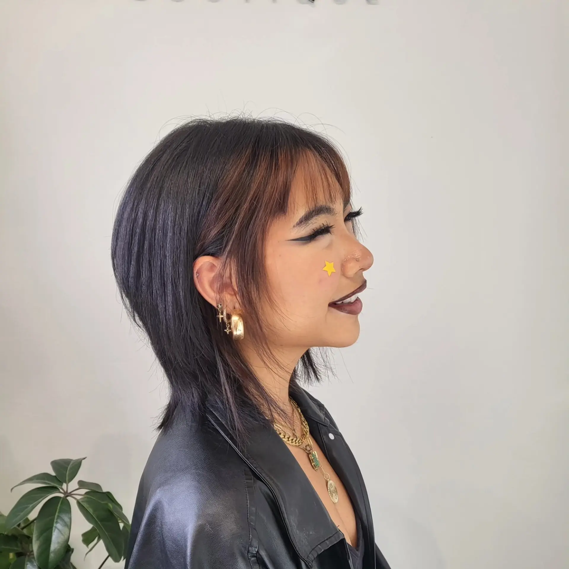 A layered short wolf cut featuring wispy see-through bangs and a tapered, textured finish around the nape. 1