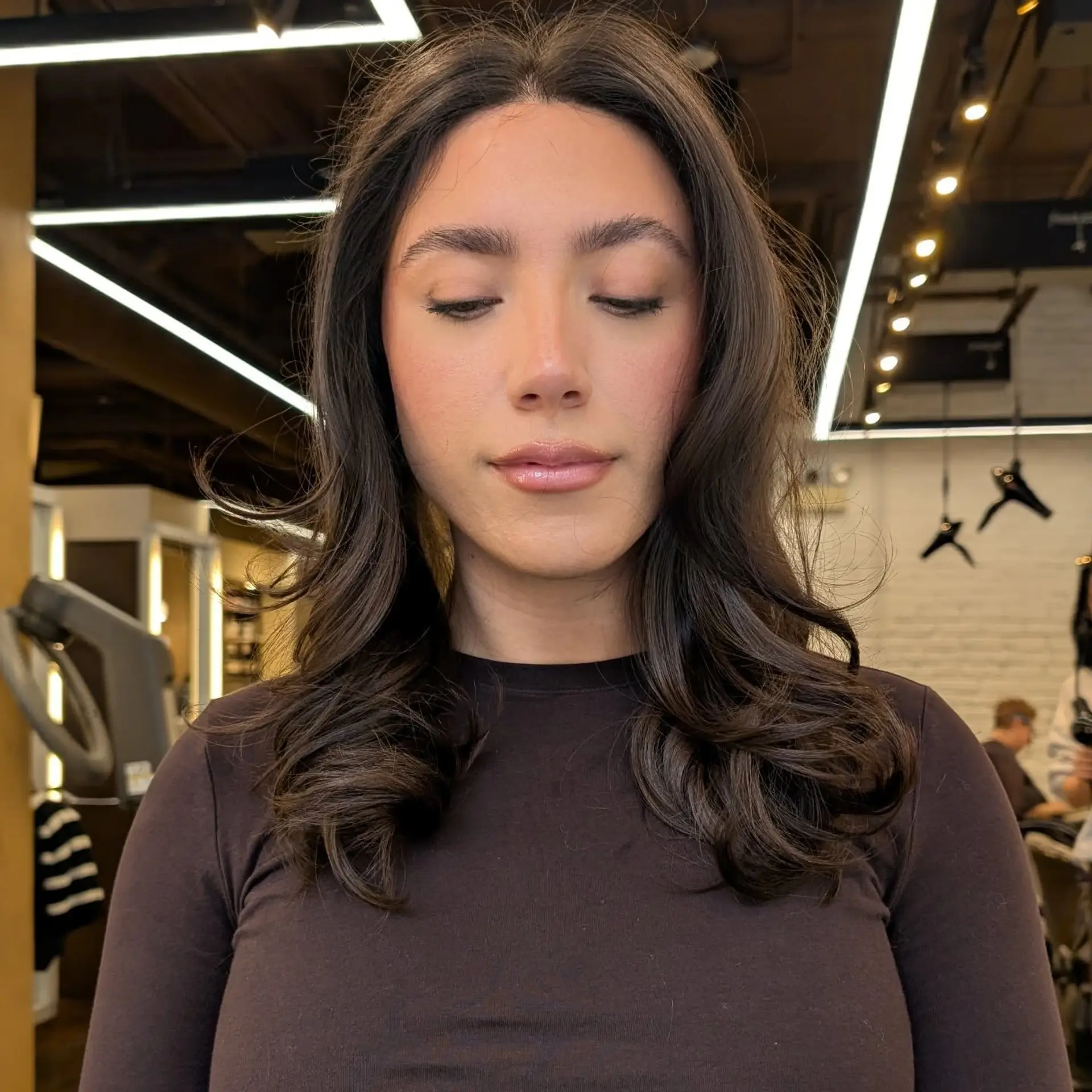 A classic blowout with face-framing layers and soft waves, perfect for a polished look. 1