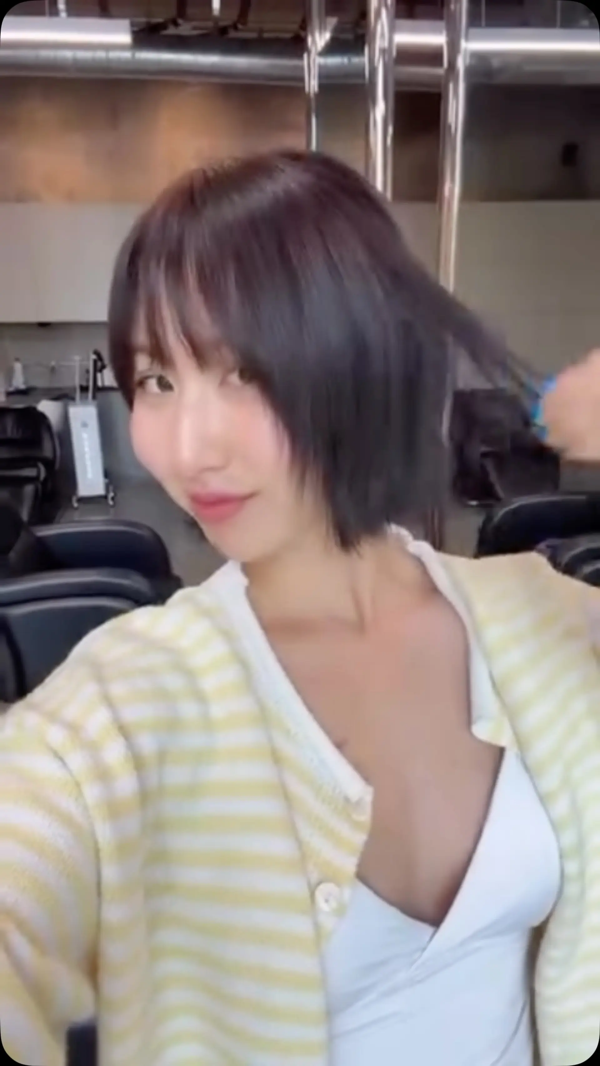 A chic, chin-length short bob featuring light, textured ends and delicate wispy bangs. 1