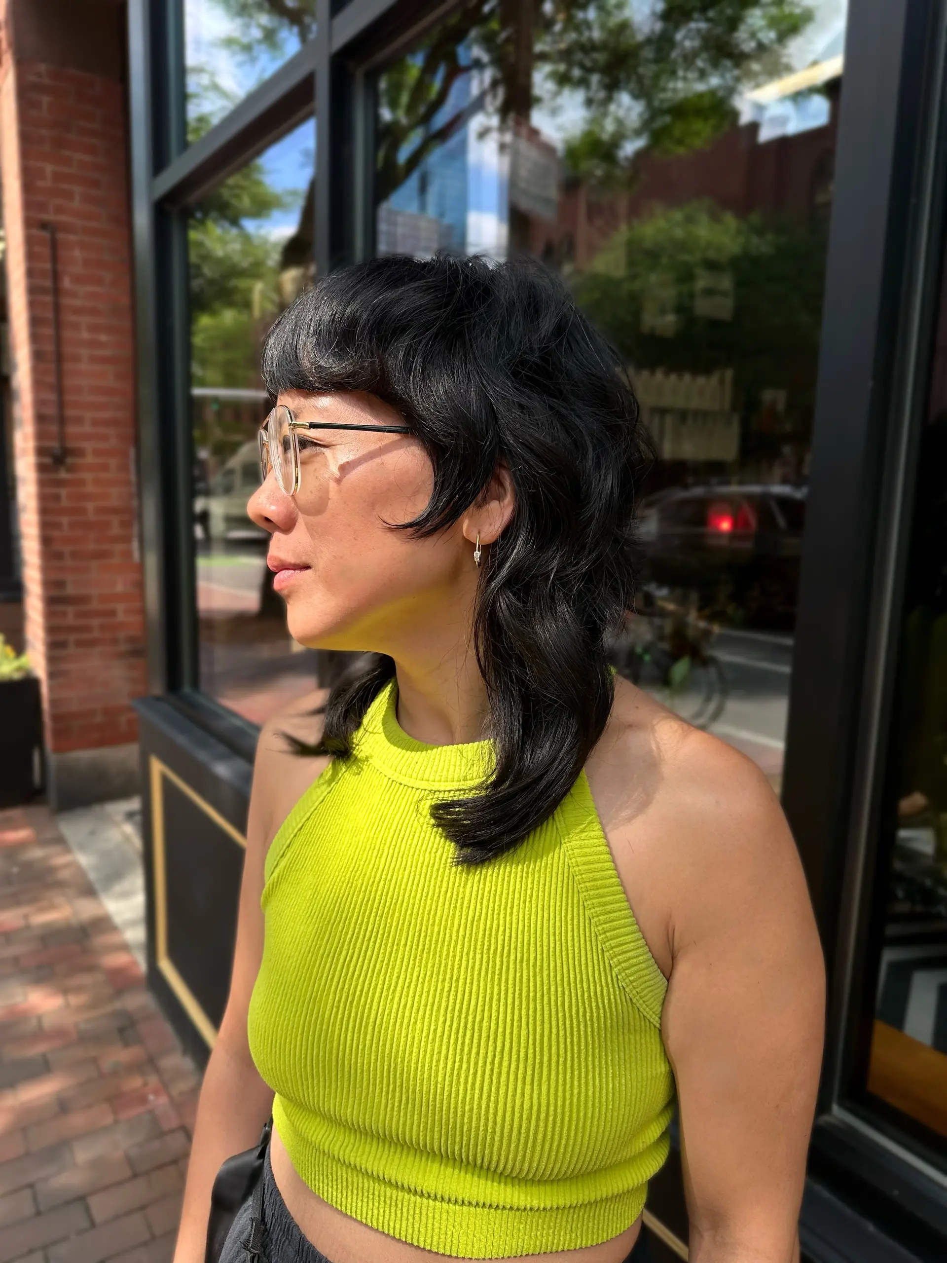 A modern disconnected mullet-shag cut with blunt micro-fringe bangs, heavily textured face-framing layers, and longer shoulder-length hair in the back. 1