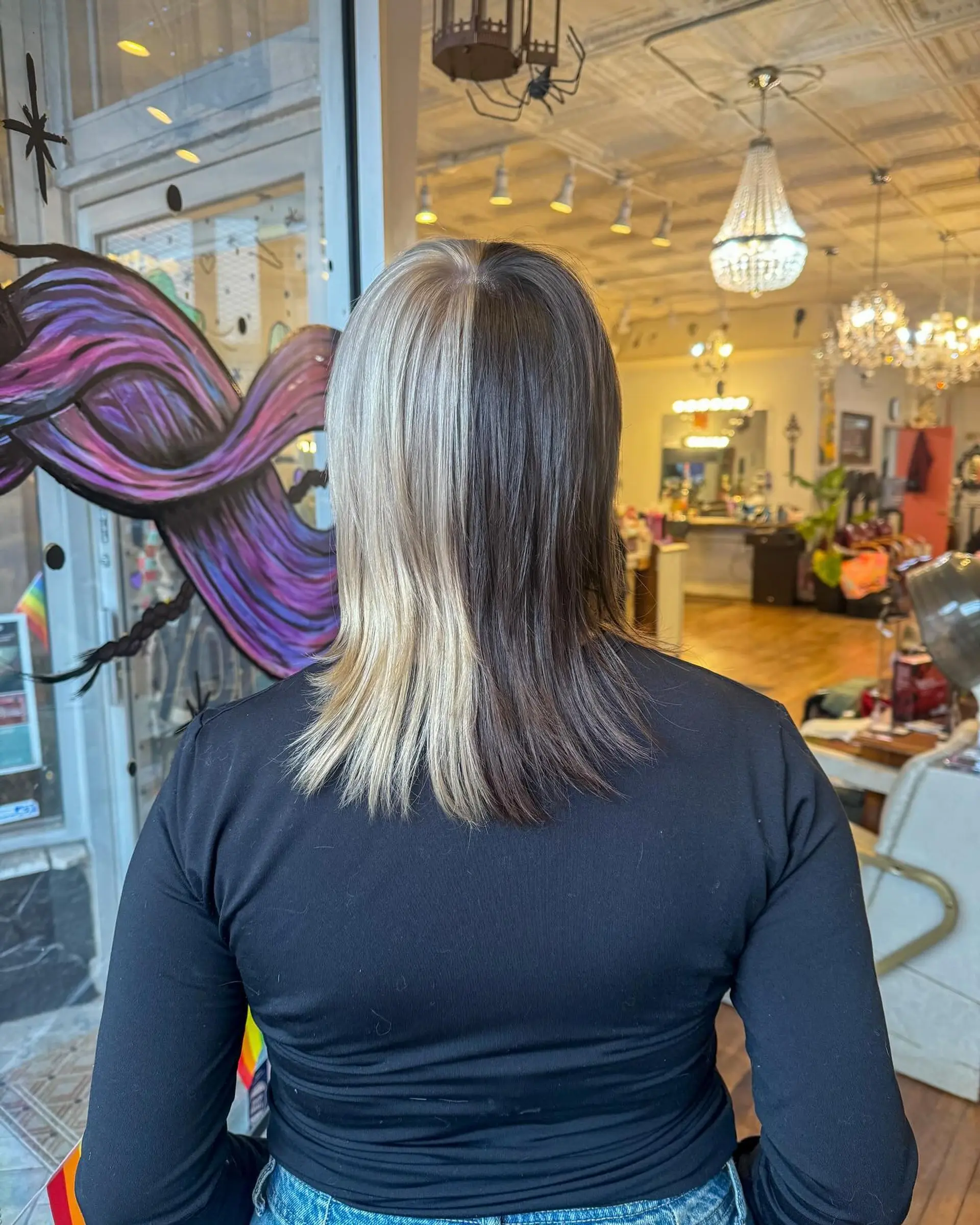 A two-tone split dye mullet with straight hair, featuring a platinum blonde and dark brown contrast. 1