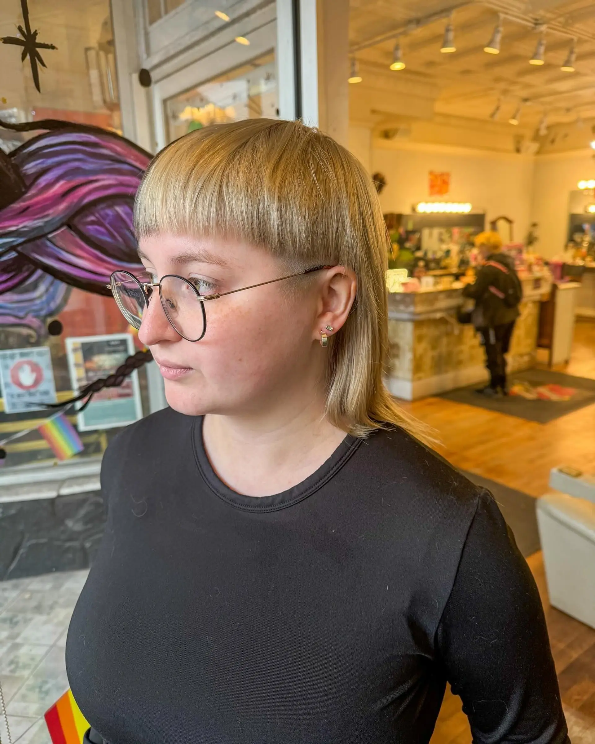 A two-tone split dye mullet with straight hair, featuring a platinum blonde and dark brown contrast. 3