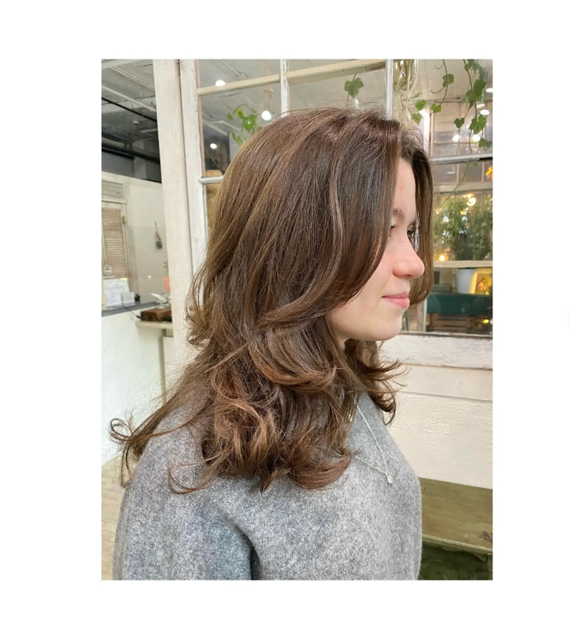 Medium length layered haircut with curtain bangs and face-framing layers. 1