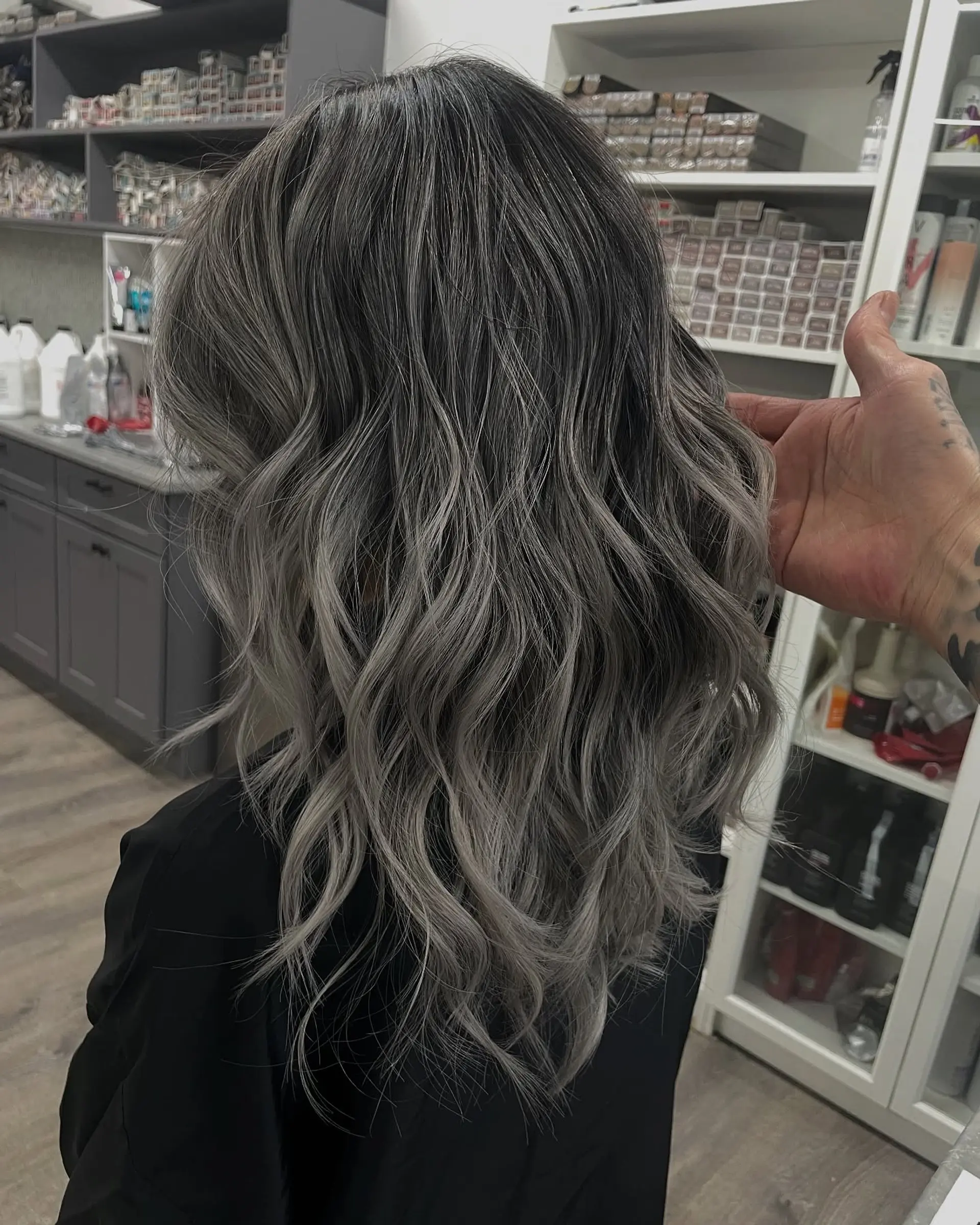 Long wavy hair with a stunning silver gray balayage. 1