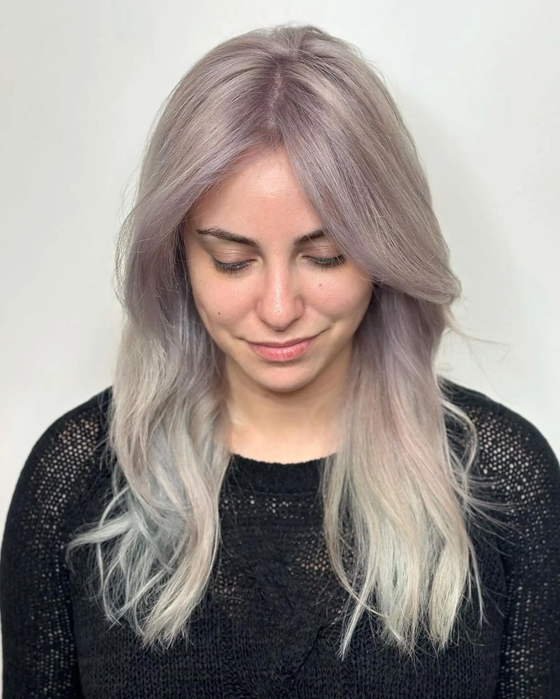 Long, wavy locks in a blend of silver, platinum, and light grey tones, parted at the center with subtle layers for added depth and movement.

Color by @simabeautynyc
 1