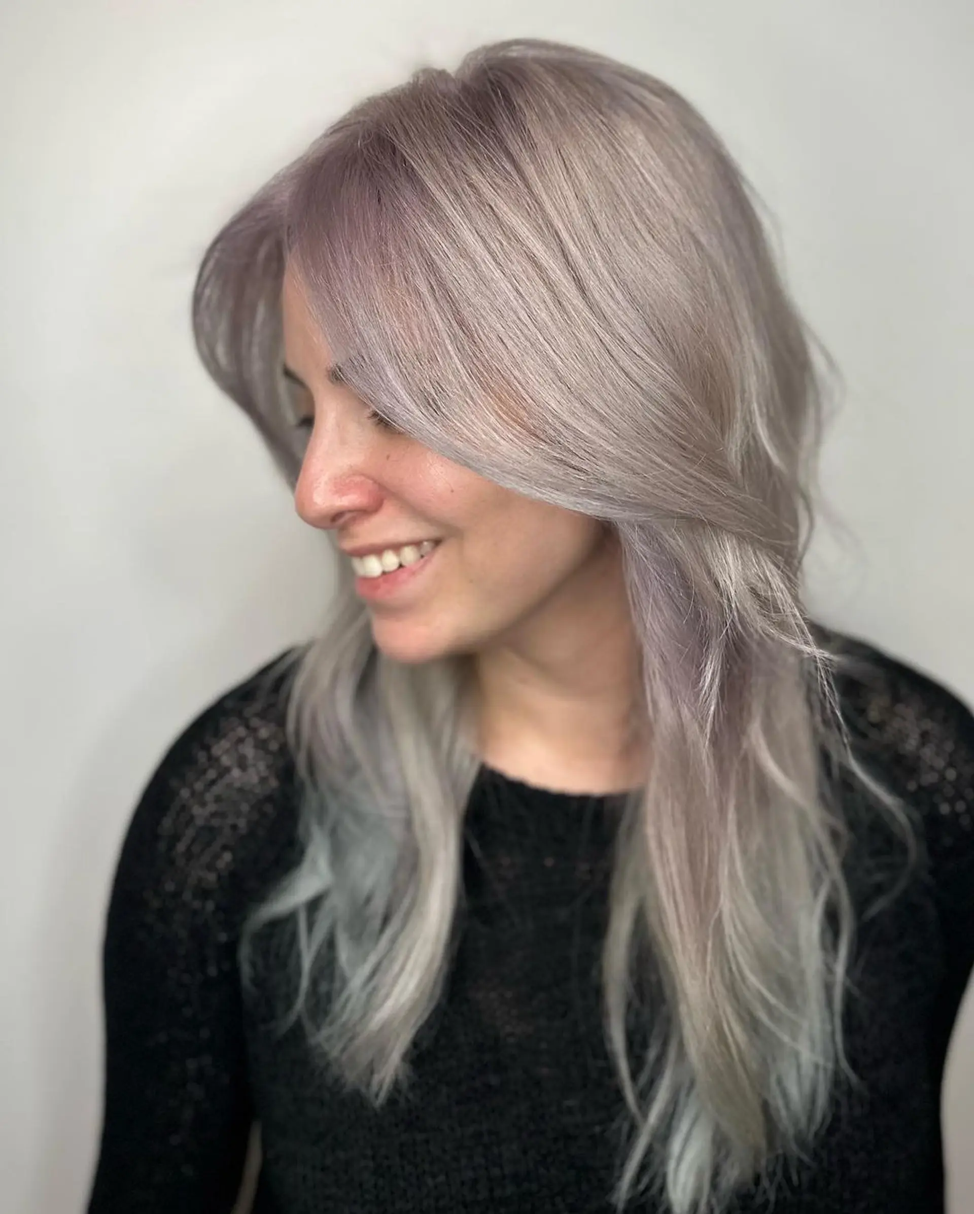 Long, wavy locks in a blend of silver, platinum, and light grey tones, parted at the center with subtle layers for added depth and movement.

Color by @simabeautynyc
 2