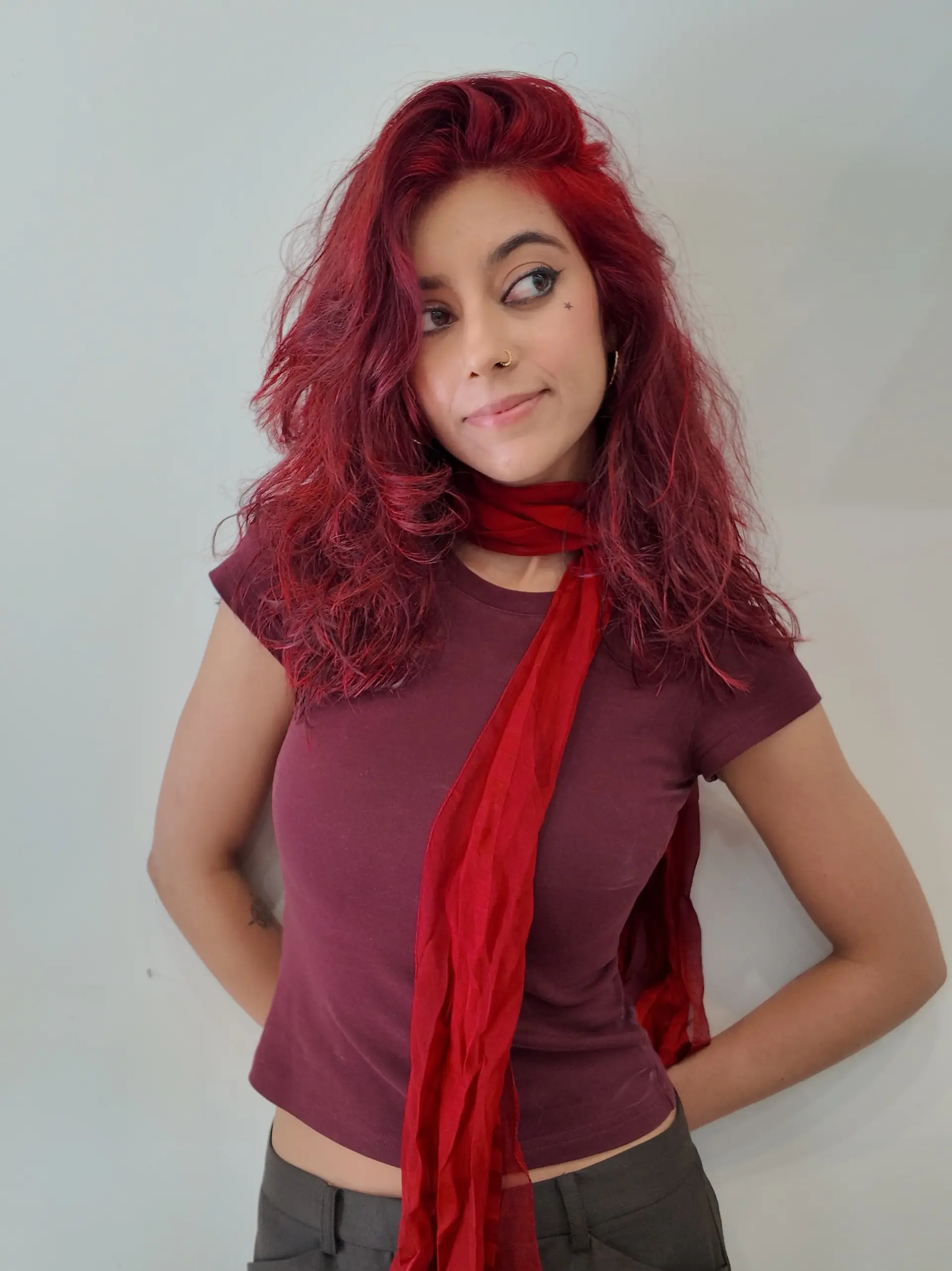Medium-length textured haircut featuring dynamic layers and soft waves in a vivid crimson red tone. 1