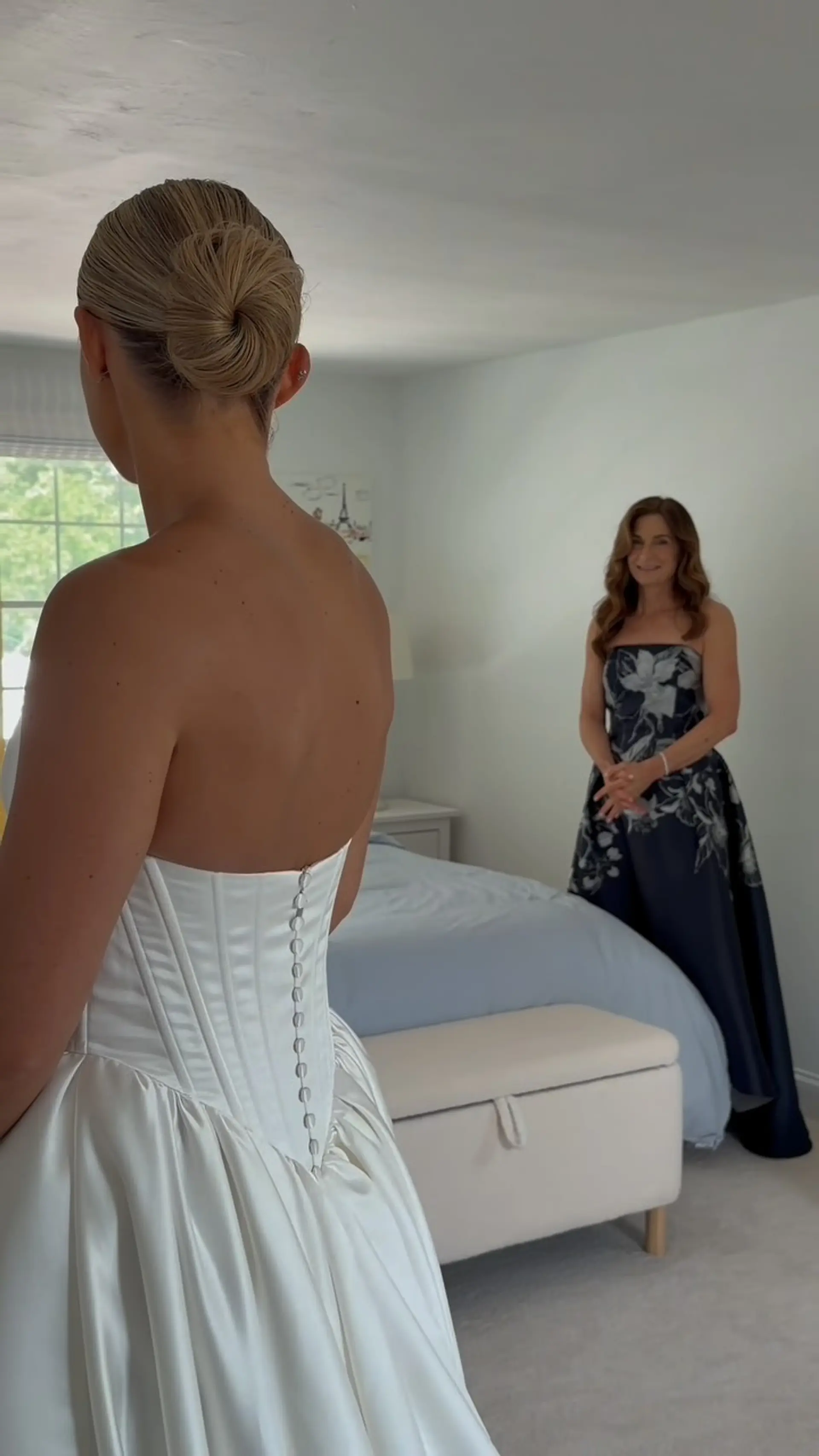A sleek and elegant bridal bun styled smoothly back into a neat, polished twisted chignon. 1