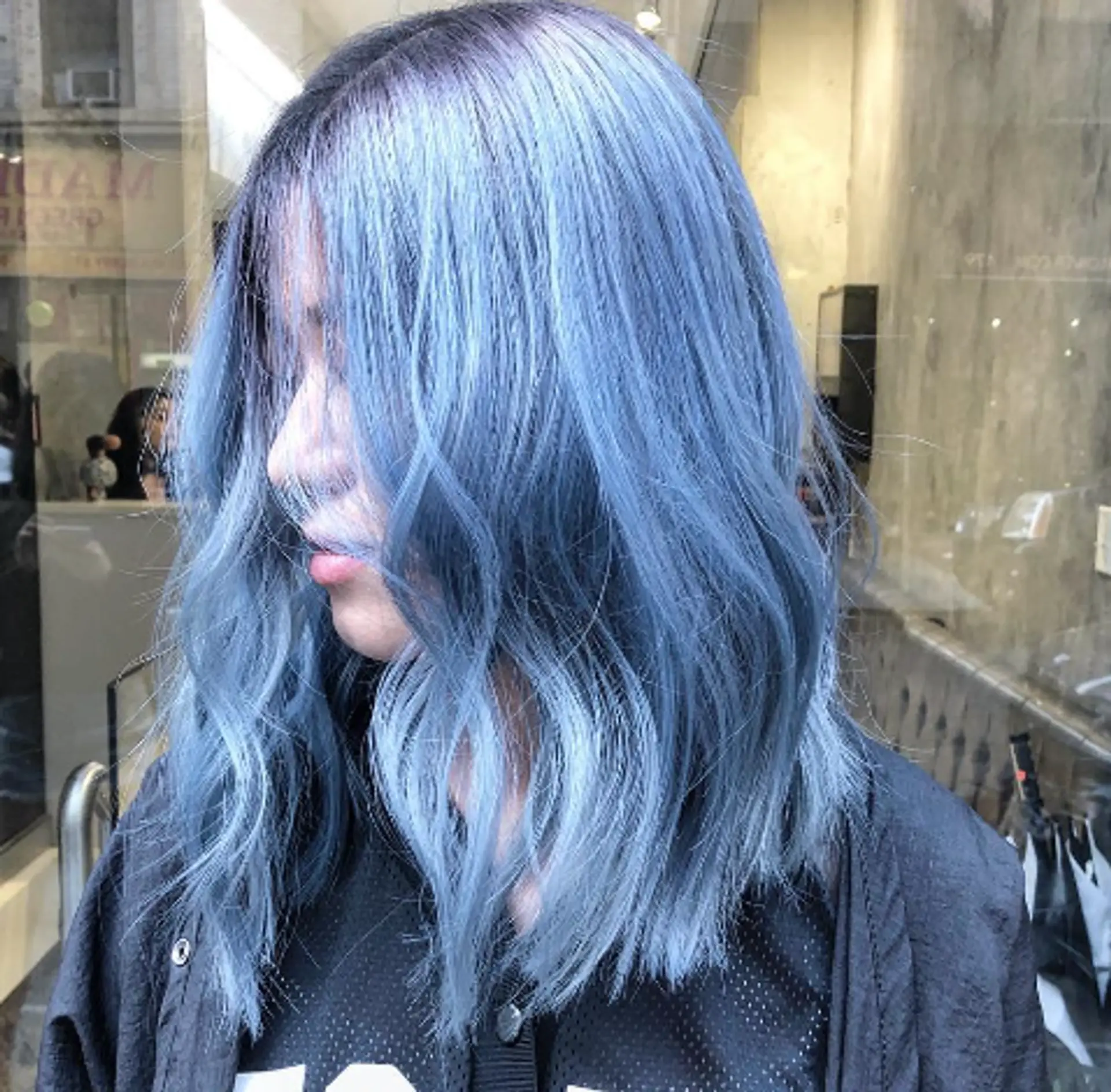 Medium-length, wavy hair with blue and silver balayage coloring, styled with a middle part and textured layers for a glossy, icy look. 1