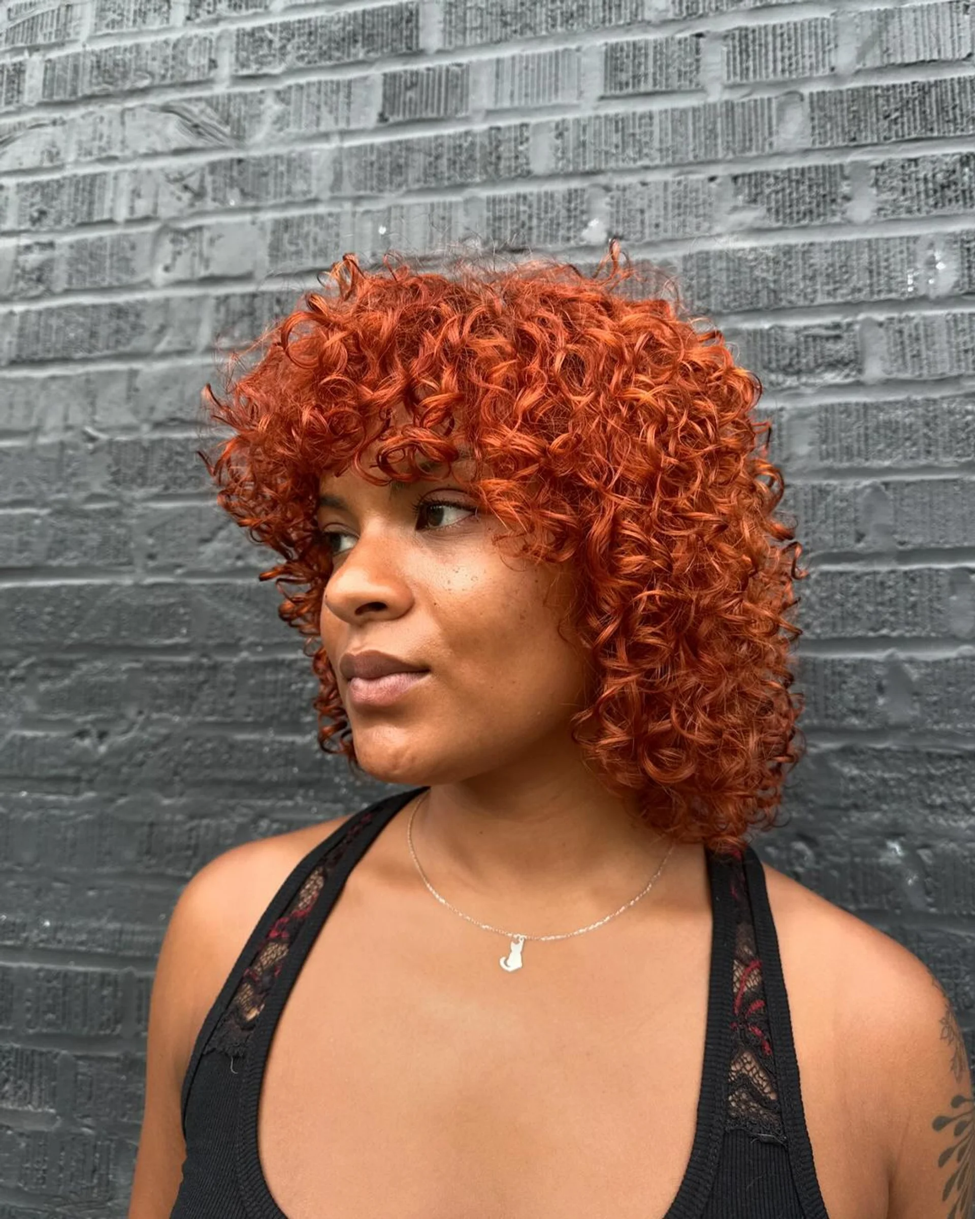 Voluminous curly bob with bangs, showcasing a baroque-inspired hairstyle trend - Preview 2