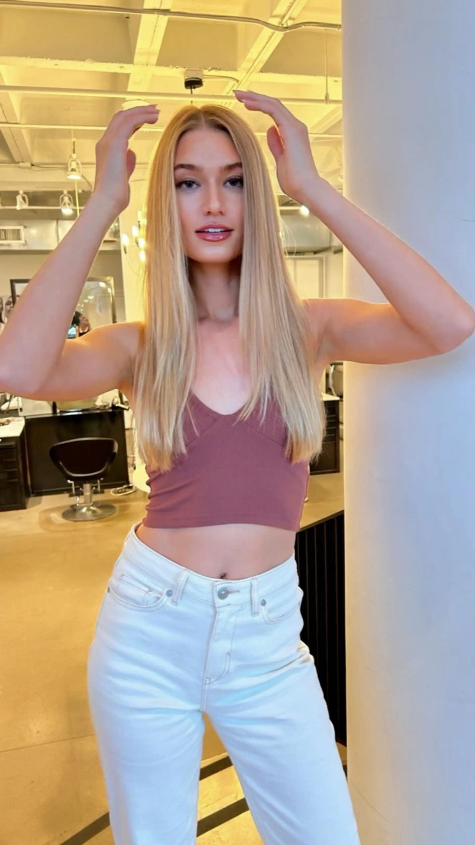 Long sleek blonde hair with a clean center part and a smooth, polished straight blowout. 1